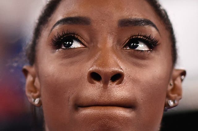 <p>USA's Simone Biles reacts during the artistic gymnastics women's team final during the Tokyo 2020 Olympic Games at the Ariake Gymnastics Centre in Tokyo</p>
