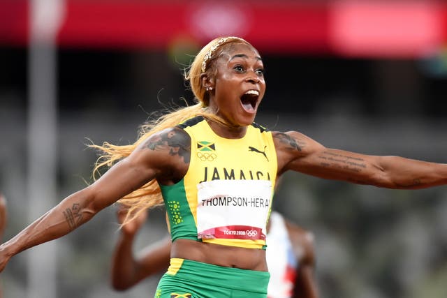 <p>Elaine Thompson-Herah of Team Jamaica crosses the finish line to win the gold medal</p>
