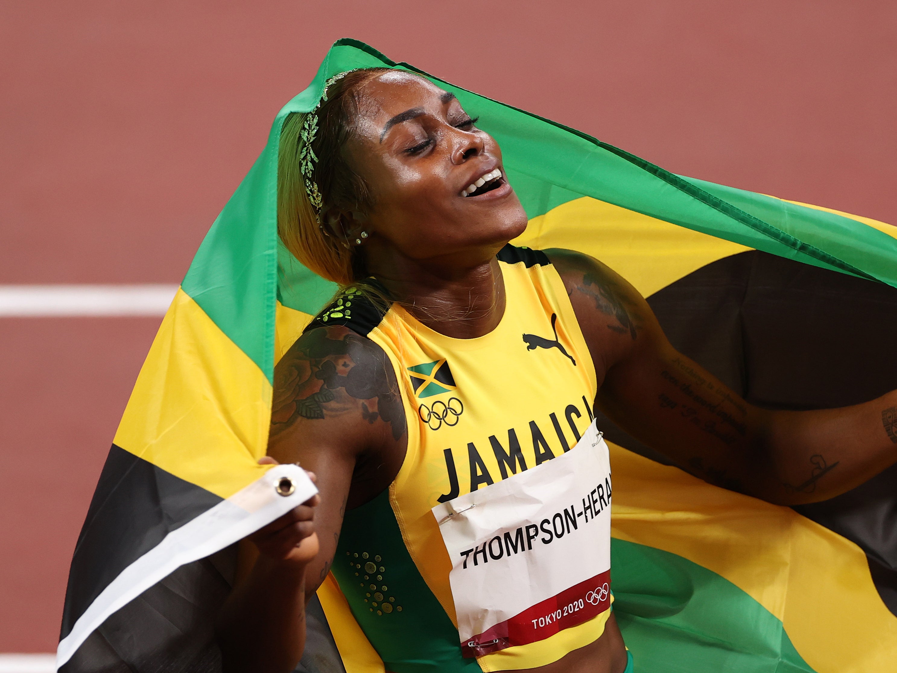 Elaine Thompson-Herah of Team Jamaica celebrates after winning the gold medal in the Women's 100m final