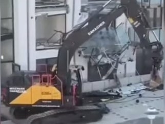 A man has destroyed a new appartment build with a digger