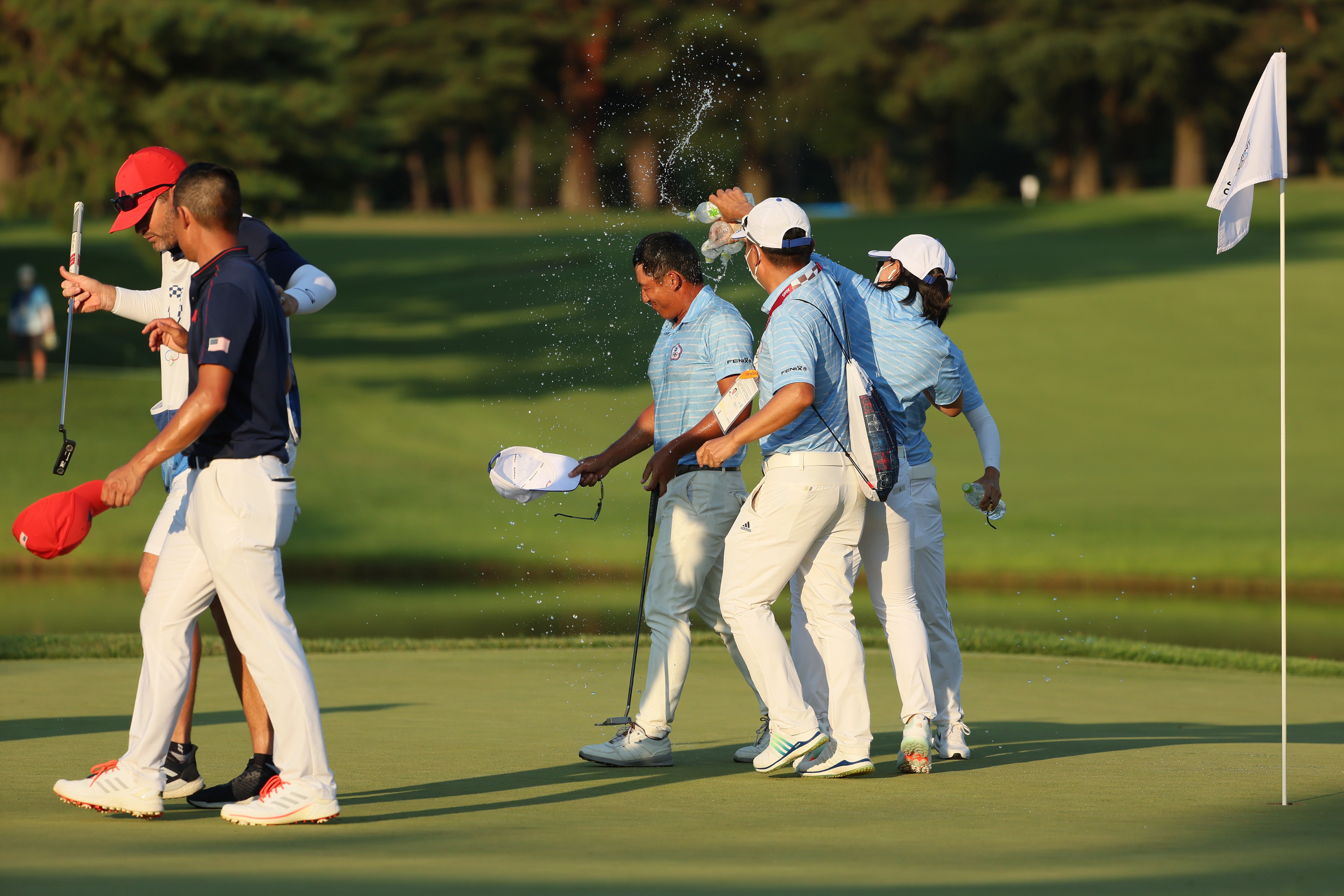 CT Pan (centre) is congratulated on winning bronze in a playoff