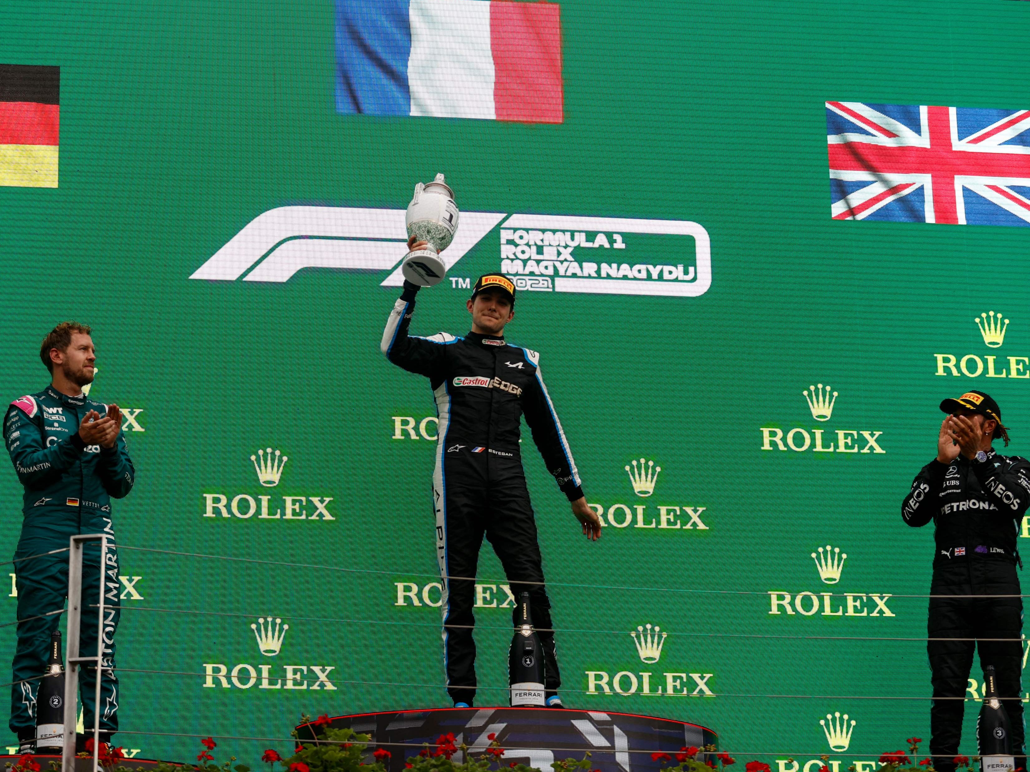 Esteban Ocon celebrates after beating Sebastian Vettel and Lewis Hamilton to victory