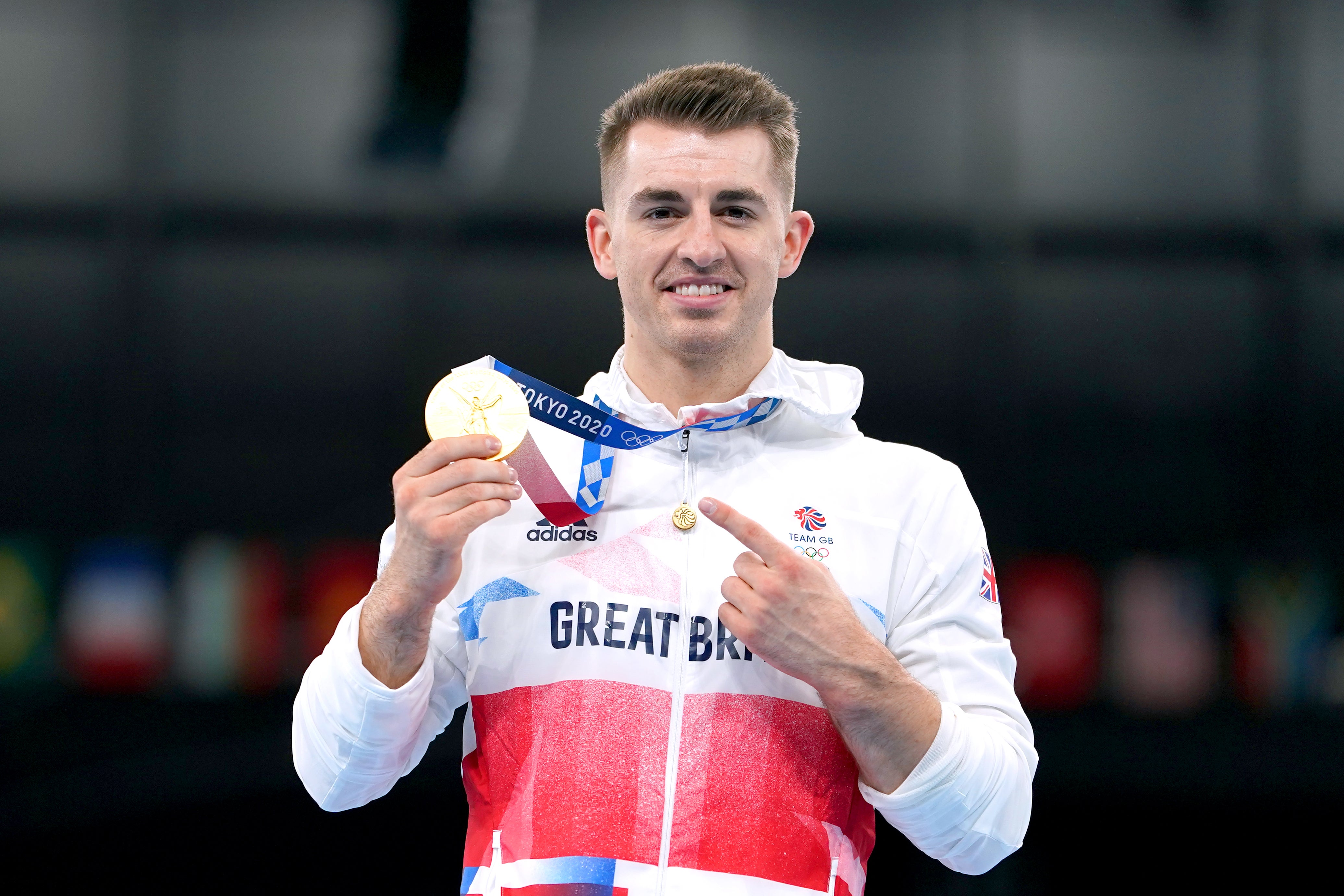 Max Whitlock celebrates with his gold medal after winning the men’s pommel horse final in Tokyo