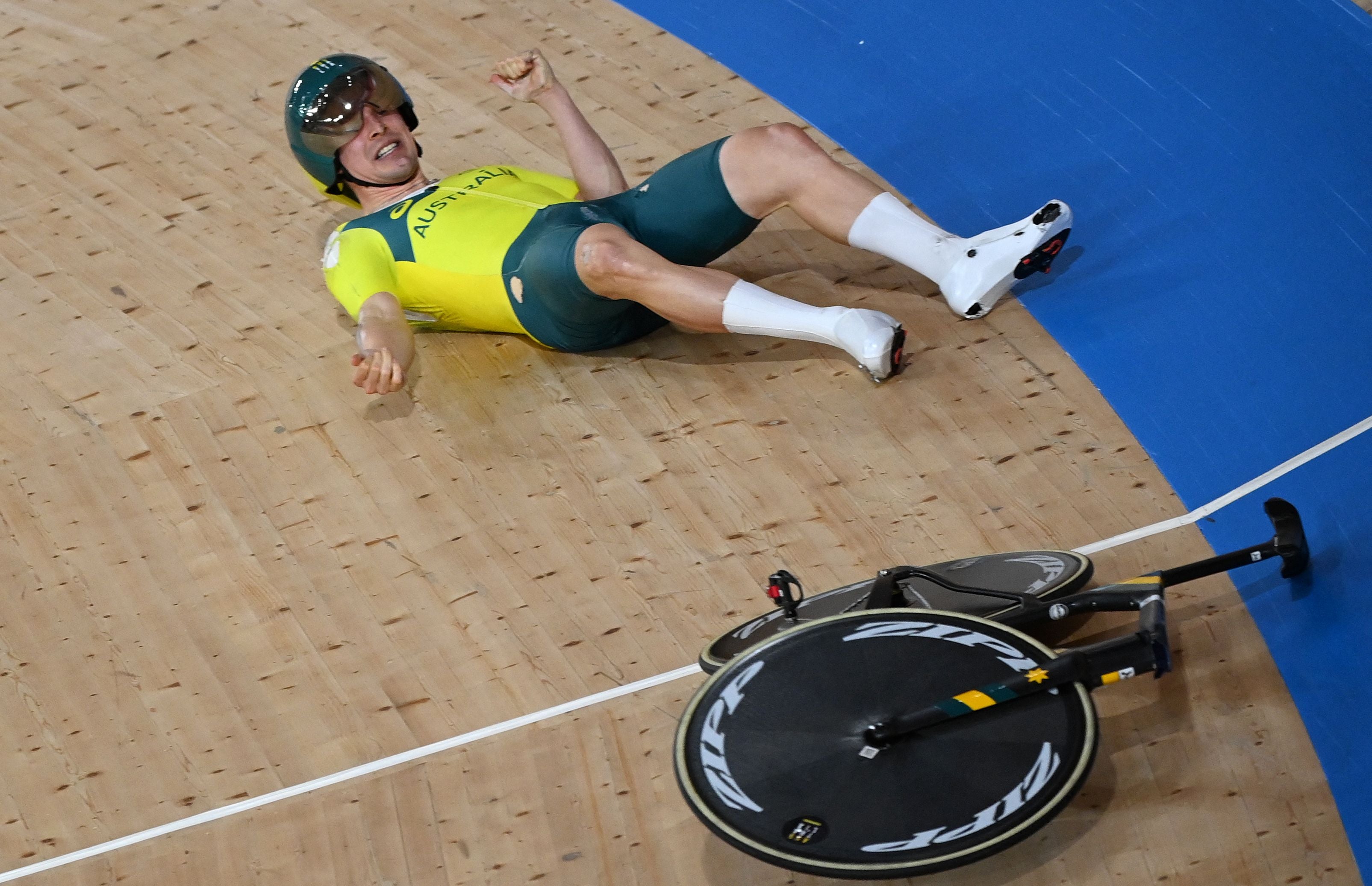 Alex Porter reacts after crashing during the men’s track cycling team pursuit qualifying