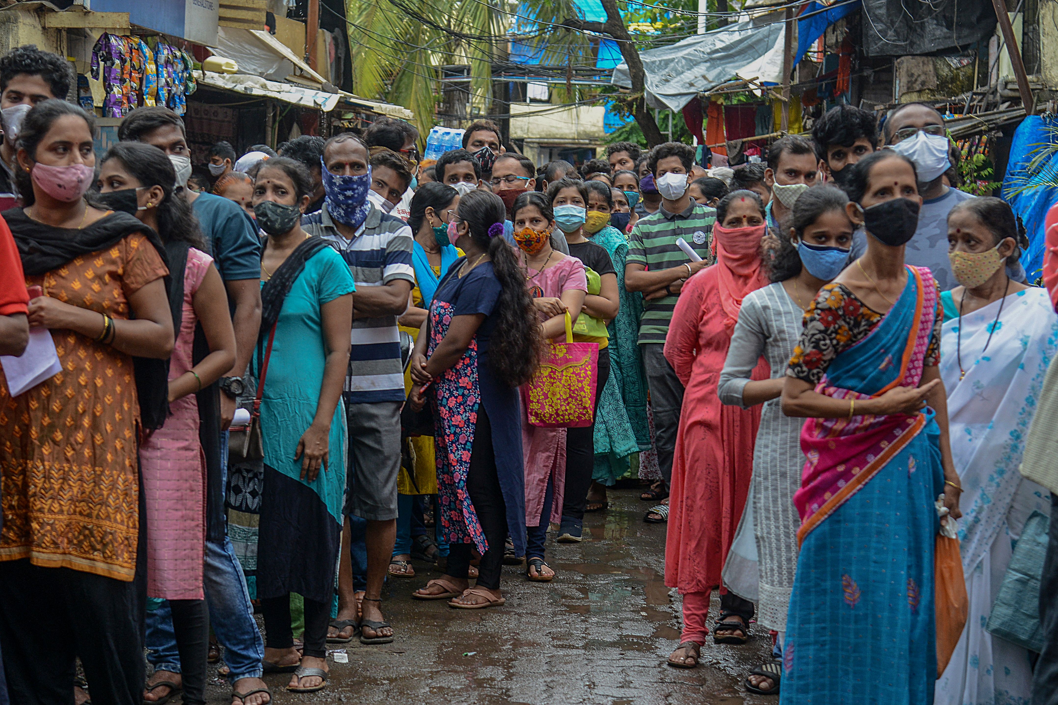 People queue up to get themselves inoculated at a residential settlement in Mumbai on 2 August 2021