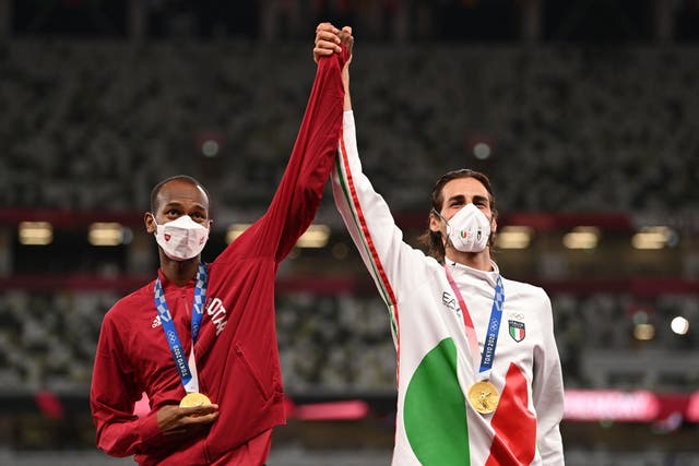 <p>Joint gold medalists Qatar’s Mutaz Essa Barshim, left, and Italy’s Gianmarco Tamberi pose on the winner’s podium for the men’s high jump</p>