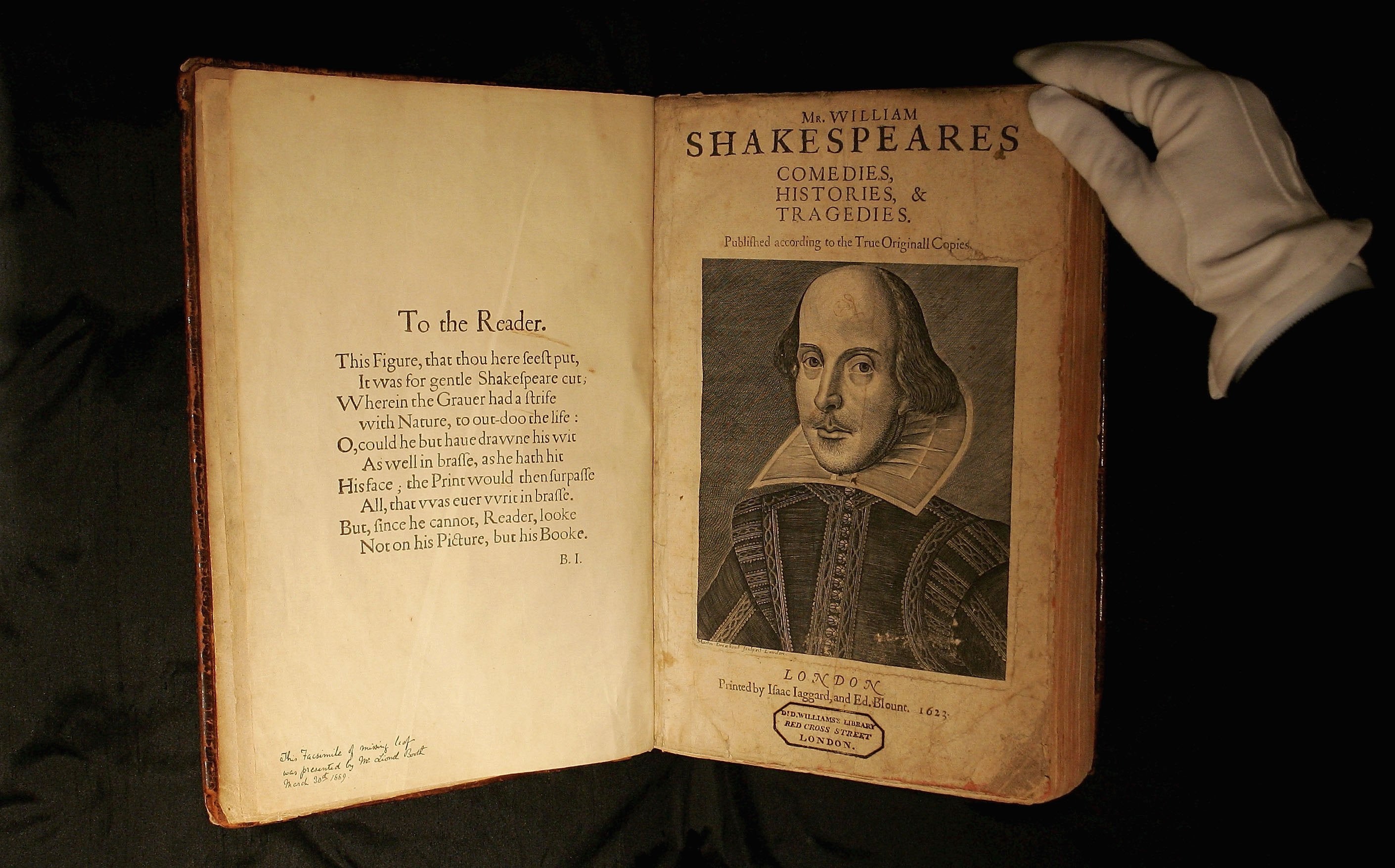 A Sotheby’s employee handles a copy of William Shakespeare, The First Folio 1623