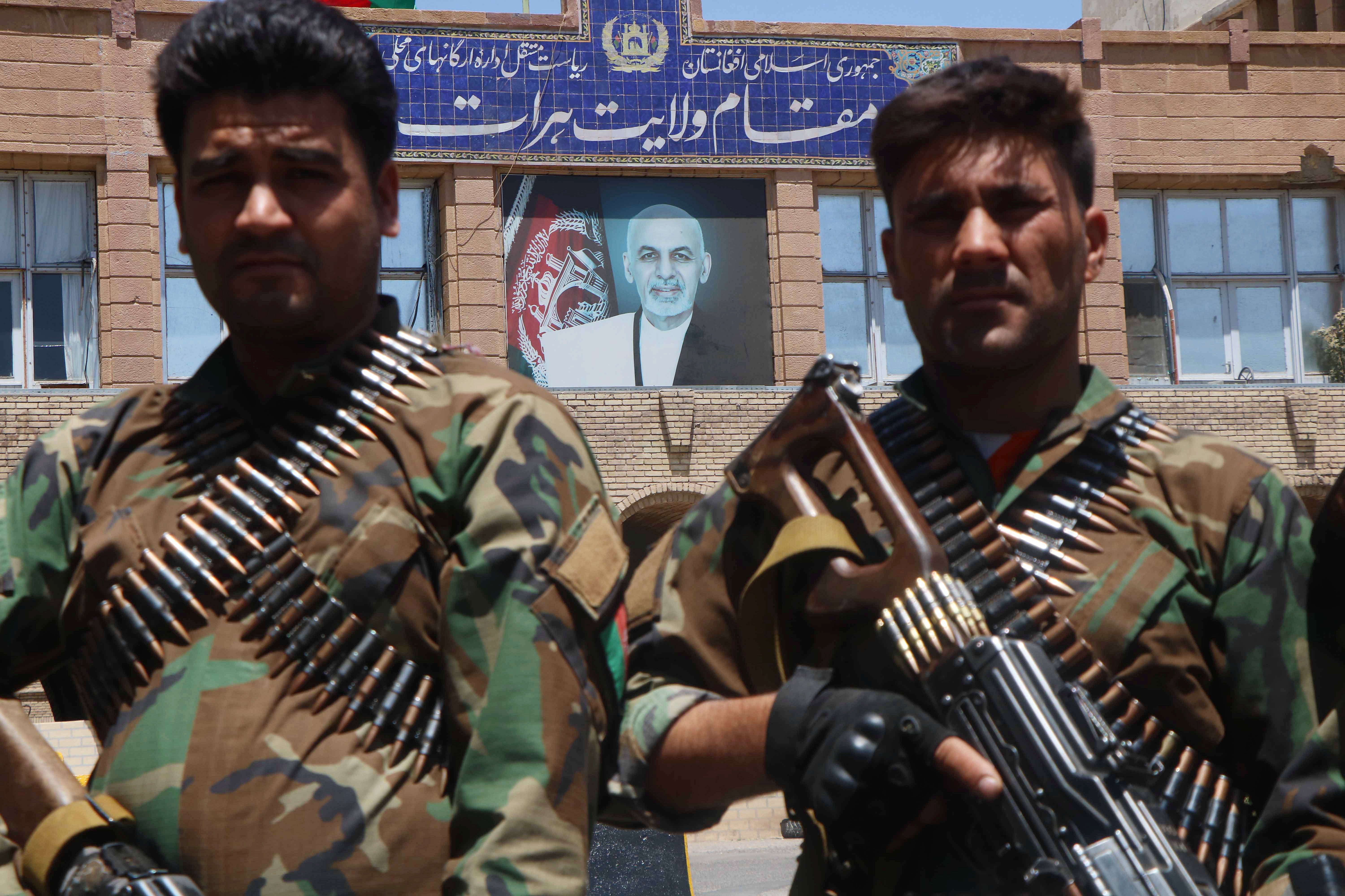 Afghan security officials arrive as part of a reinforcement to fight against Taliban militants as they push to gain access to the city in Herat