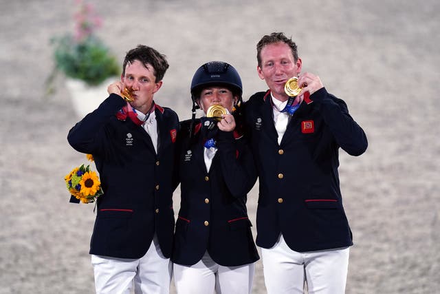 Laura Collett, Tom McEwen and Oliver Townend celebrate their gold medals (Adam Davy/PA)