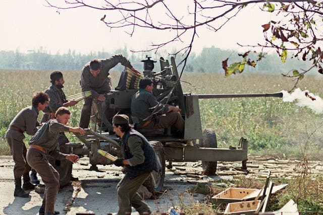 <p>Serb volunteers in Borovo Selo load a cannon on the front line during the fighting for Vukovar against the Croatian forces, 5 October 1991</p>