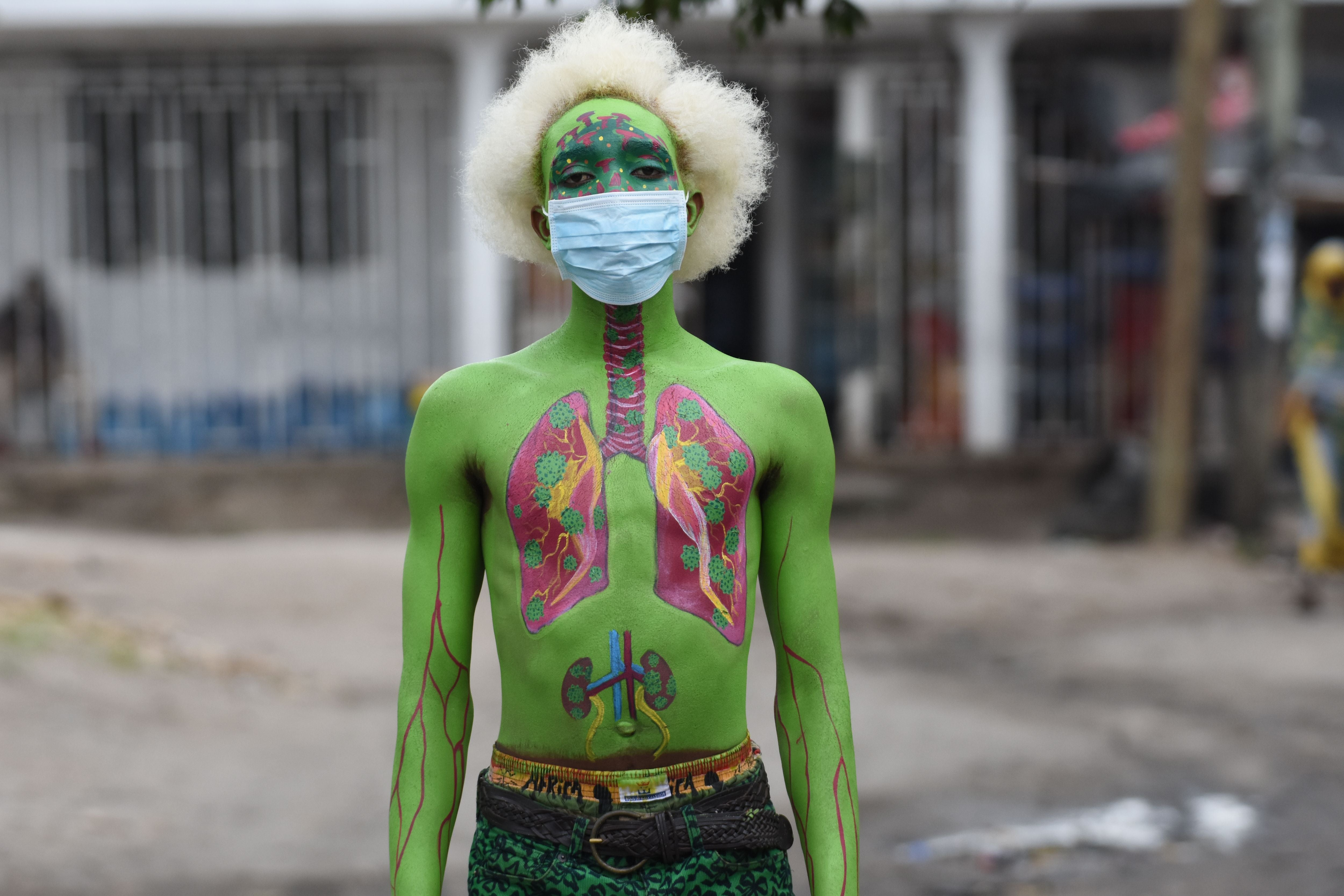 Tanzanian performing artist Alex Kalemera, also known as Tanzania Joker poses for a photograph as he raises awareness against the spread of the Covid-19