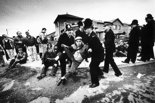 <p>A peaceful demonstrator being removed away from where Prime Minister Margaret Thatcher was due to arrive to visit the Eldonian Housing Estate in Liverpool during her tour of the North West in 1989 </p>