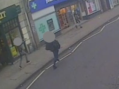 A CCTV still showing undercover armed police officers chasing Amman, right, with their guns drawn after he stabbed two people in the Streatham attack