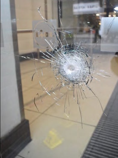 A bullet hole in the front of a Lidl supermarket in Streatham High Road after police opened fire at terrorist Sudesh Amman
