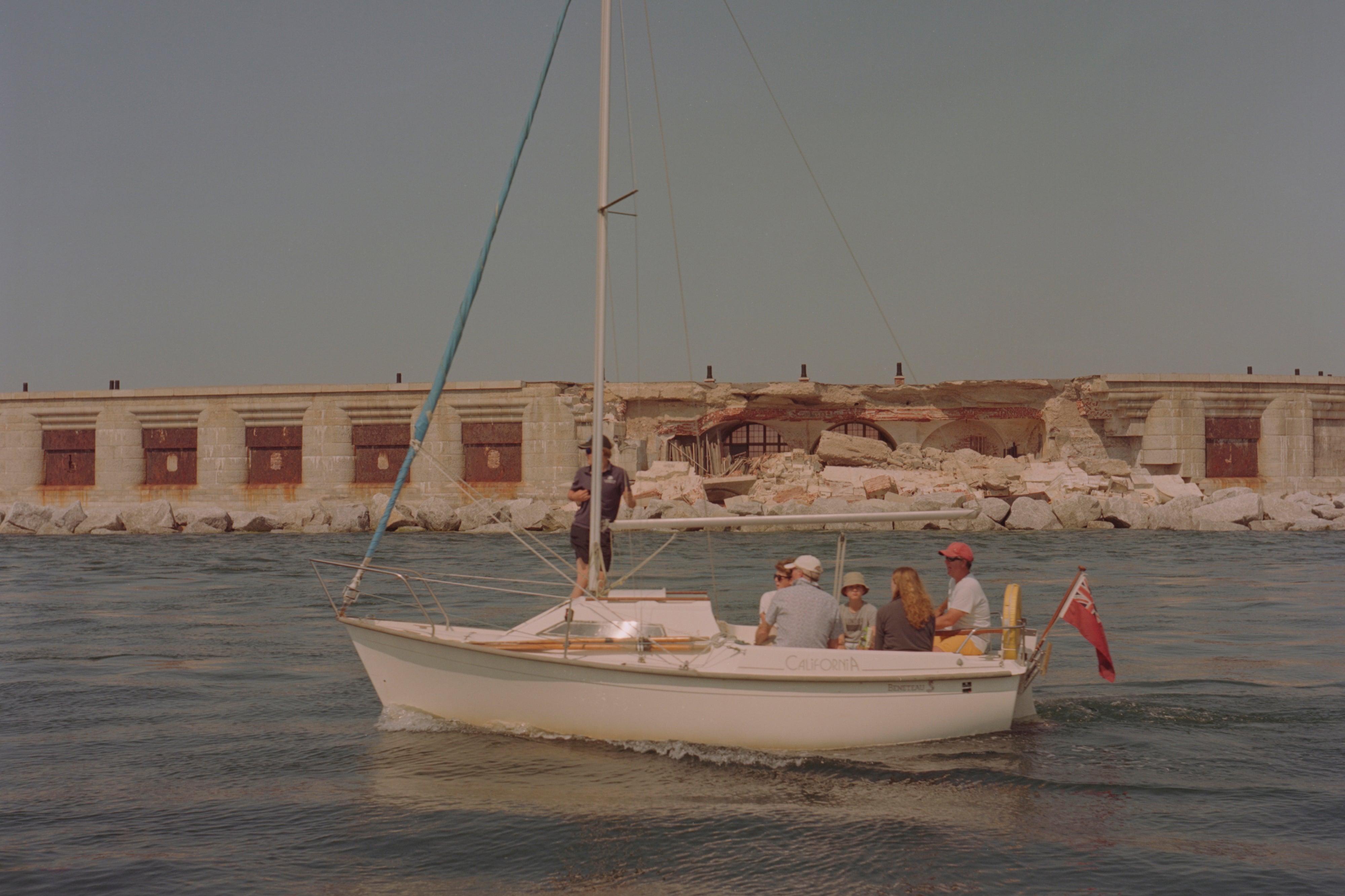A sailing boat passes by Hurst Castle, alongside the collapsed wall of the east wing