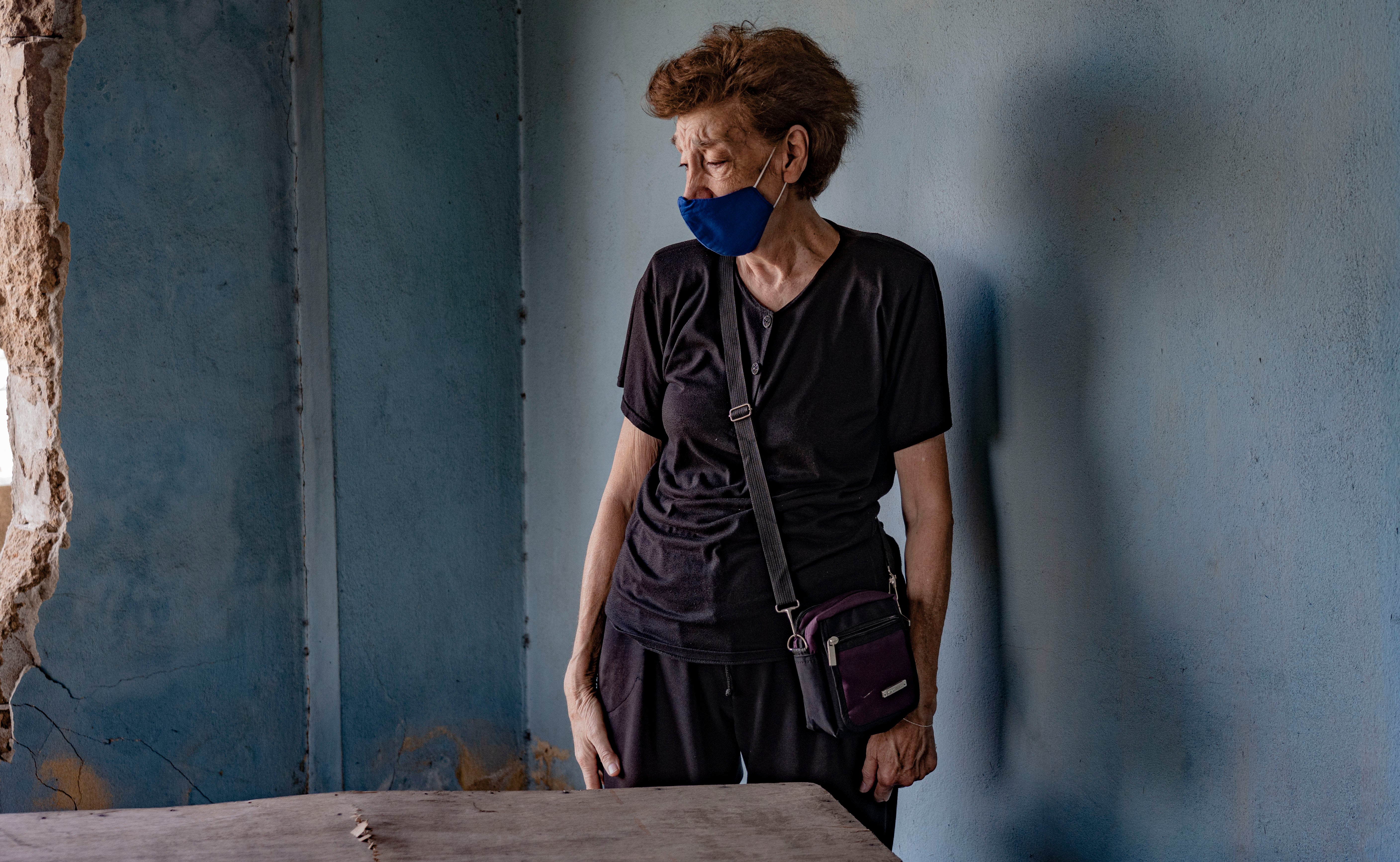 Makrouhi Arkanian in the destroyed remains of her home that one year on has still not been repaired