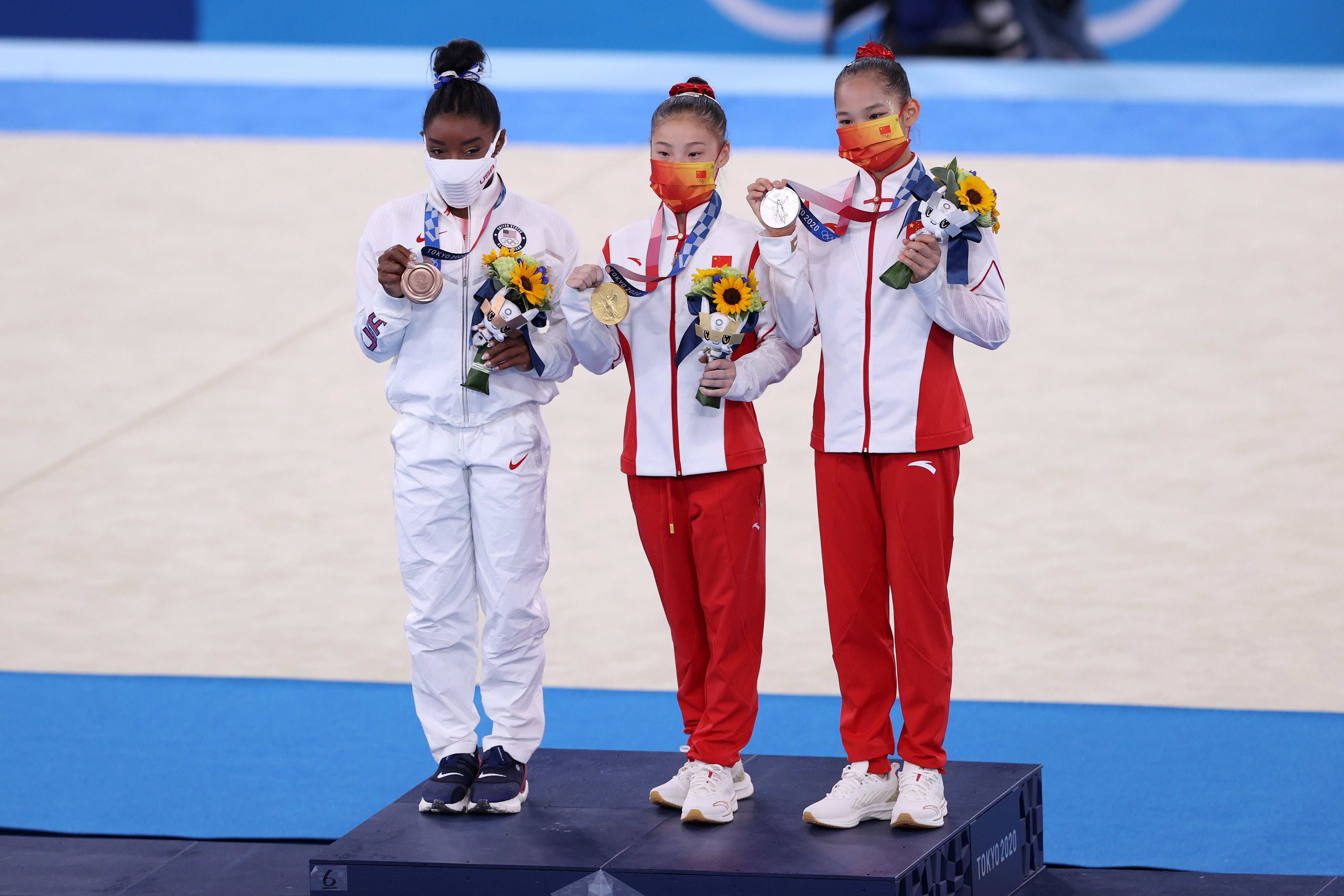 Silver medalist Xijing Tang of Team China, gold medalist Chenchen Guan of Team China and bronze medalist Simone Biles of Team United States