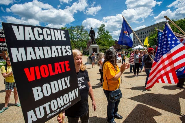 <p>Protesters at an anti-mask and anti-vaccine rally in New Hampshire, 15 May</p>