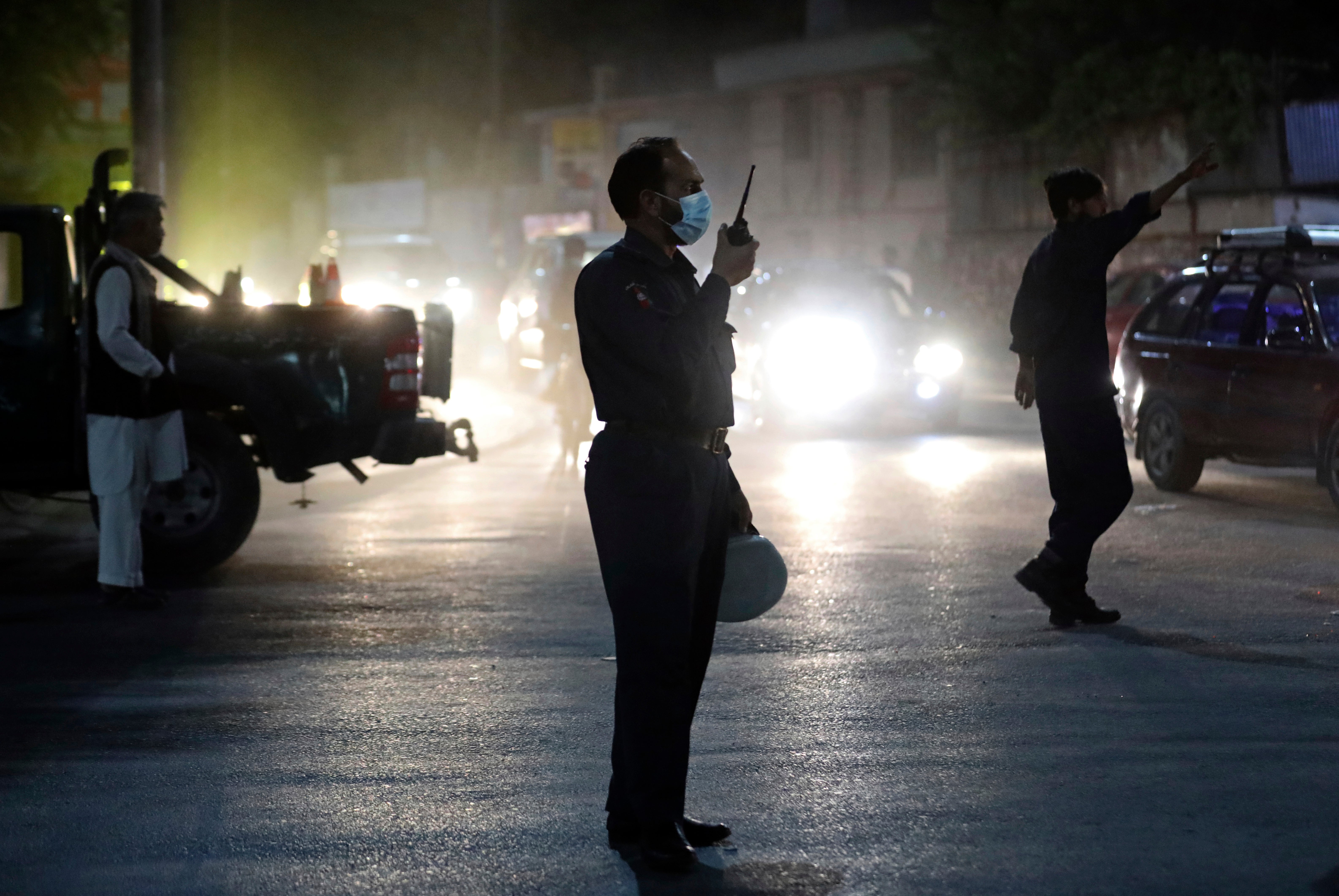 Afghan security personnel work at the site of Tuesday’s powerful explosion in Kabul