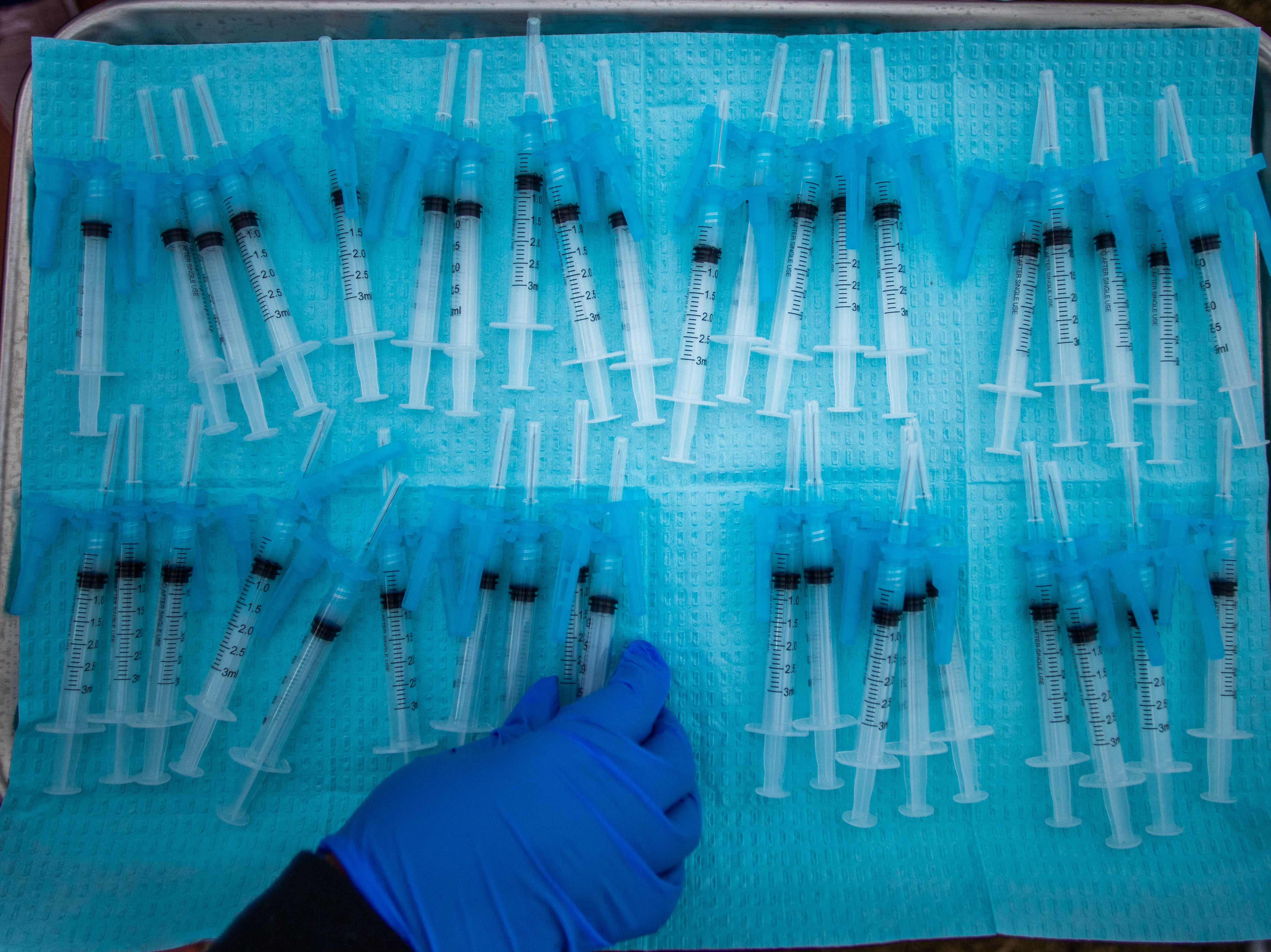 <p>A nurse makes Moderna Covid-19 vaccines ready to be administered at a vaccination site at Kedren Community Health Center, in South Central Los Angeles, California on February 16, 2021</p>