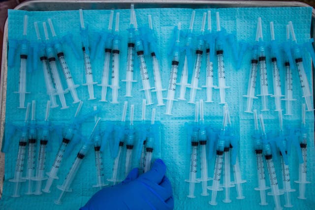 <p>A nurse makes Moderna Covid-19 vaccines ready to be administered at a vaccination site at Kedren Community Health Center, in South Central Los Angeles, California on February 16, 2021</p>