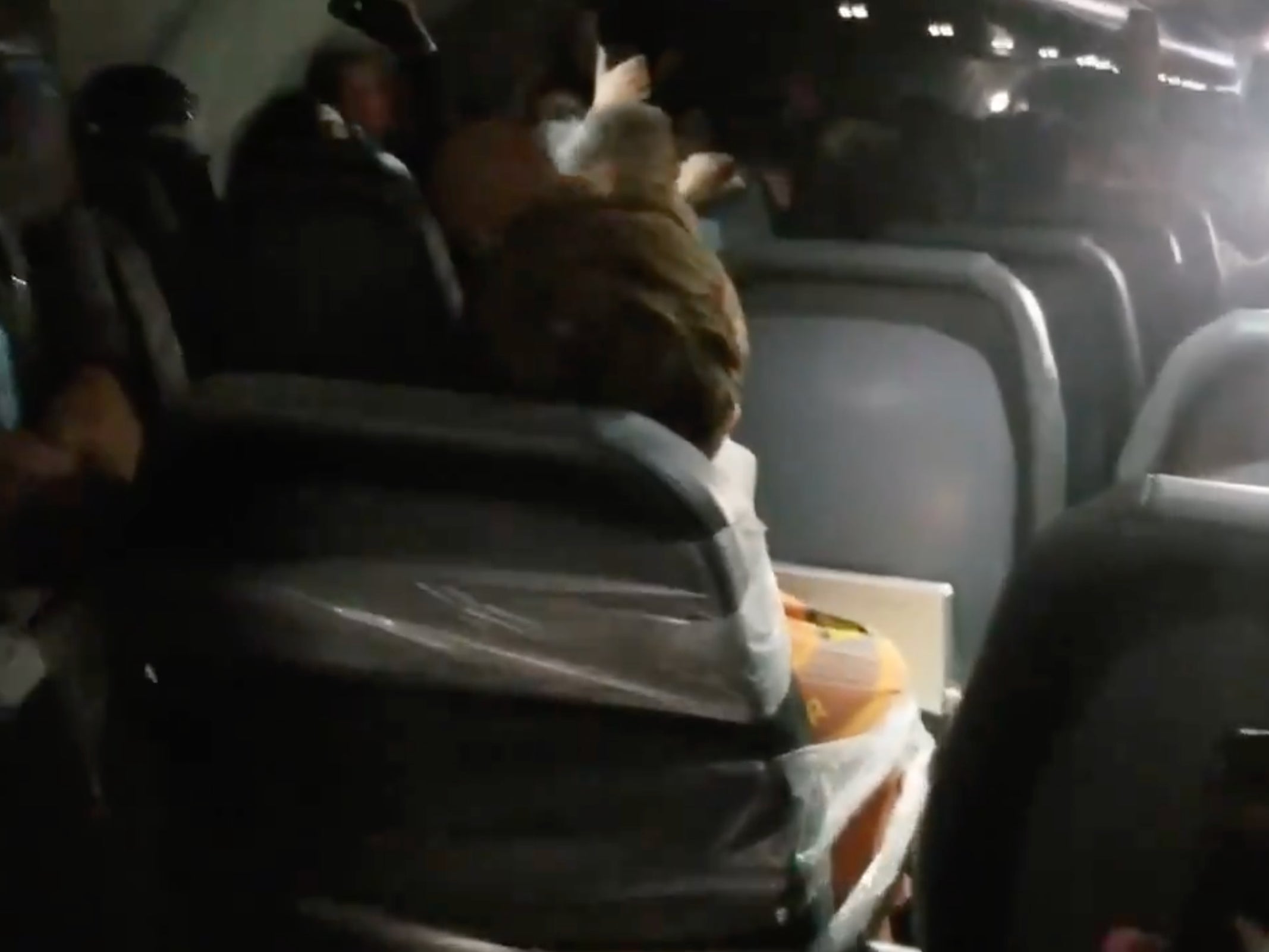 airplane passenger duct taped to seat