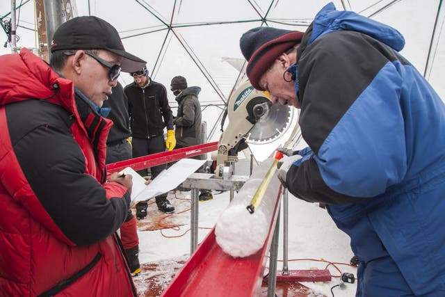 <p>Yao Tandong, left, and Lonnie Thompson, right, processing an ice core drilled from the Guliya Ice Cap in the Tibetan Plateau in 2015</p>