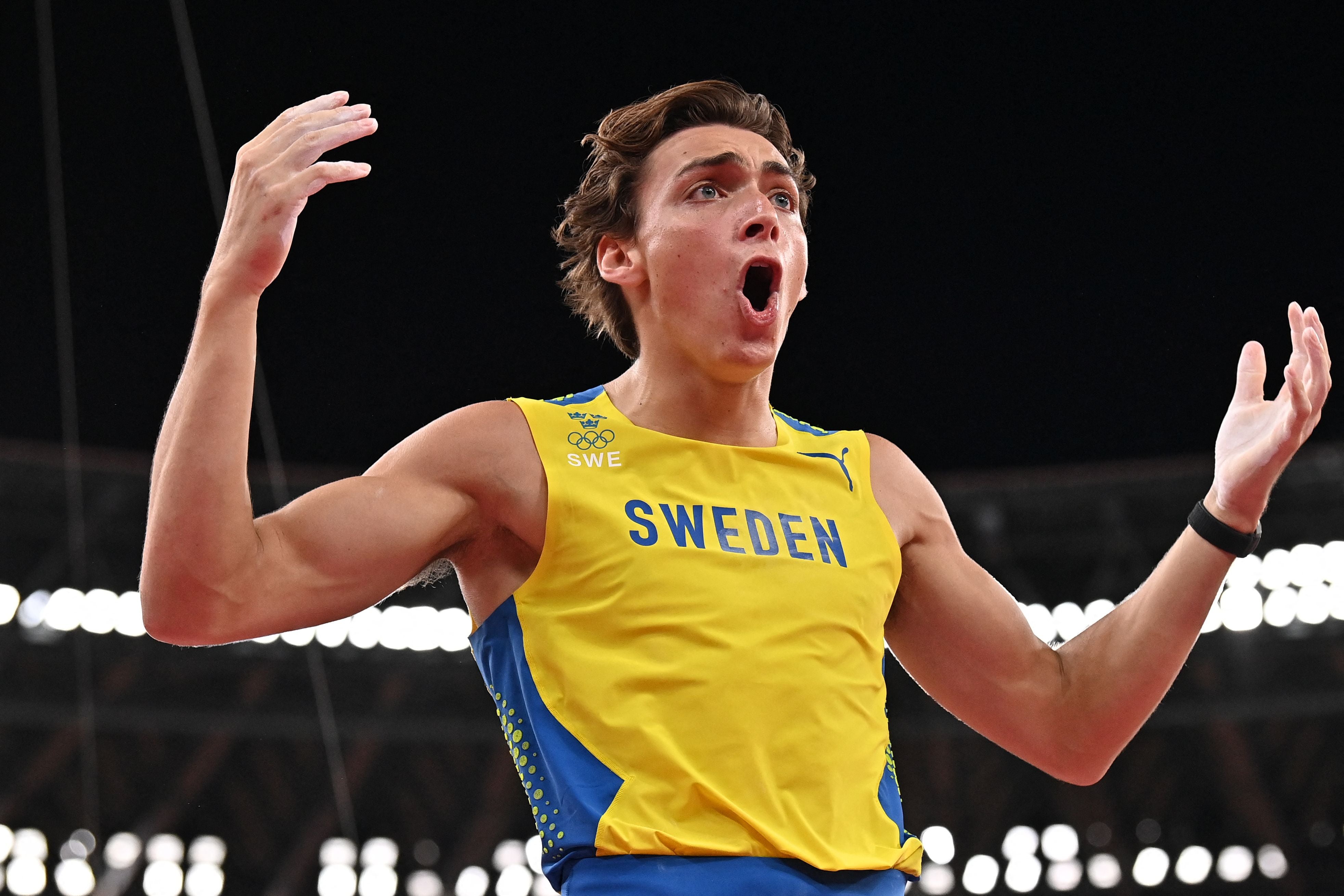 Sweden's Armand Duplantis celebrates after clearing the bar to attempt the gold medal as he competes in the men's pole vault final during the Tokyo 2020 Olympic Games at the Olympic Stadium in Tokyo on August 3, 2021