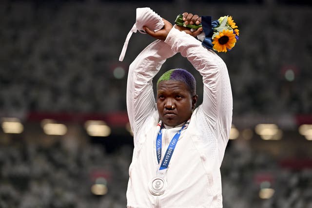 <p>Second-placed USA's Raven Saunders gestures on the podium with her silver medal after competing the women's shot put event during the Tokyo 2020 Olympic Games at the Olympic Stadium in Tokyo on August 1, 2021.</p>