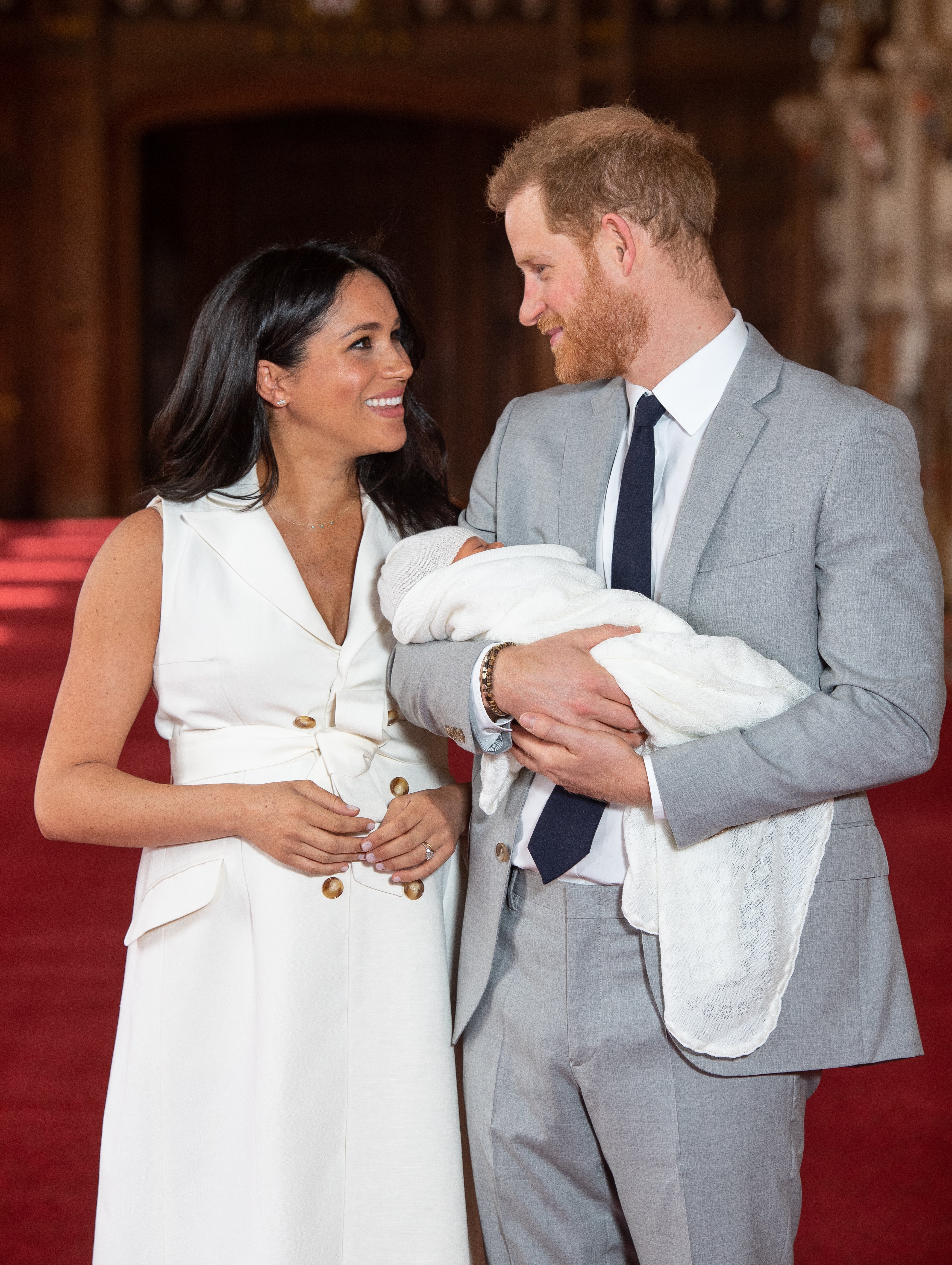 Meghan chose a white double-breasted shirt dress.