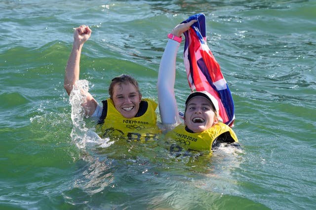 <p>Hannah Mills and Eilidh McIntyre celebrate their golds in the sea </p>