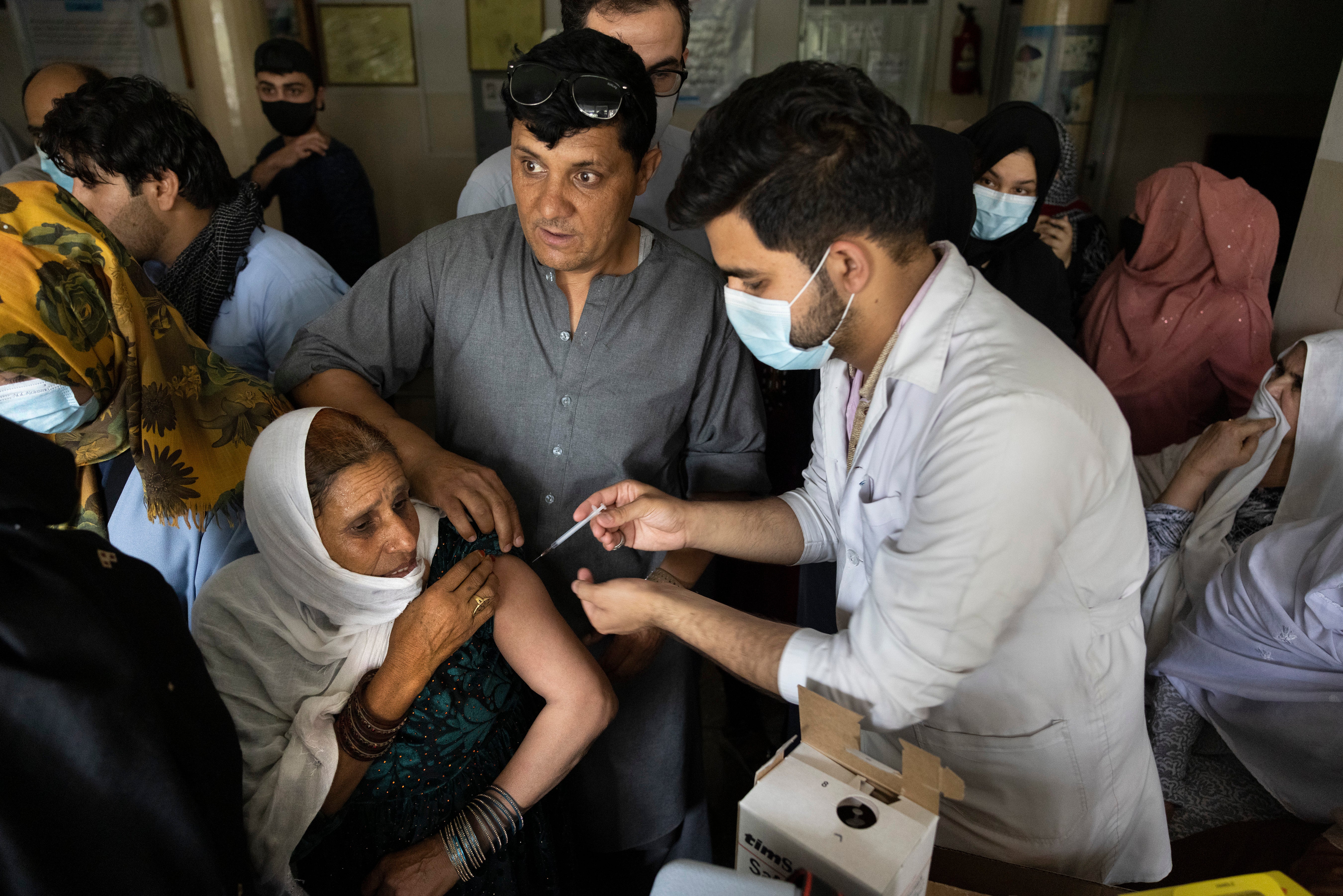 Doctor Roheed Mureed delivers a Covid jab to an Afghan woman at a hospital in Kabul