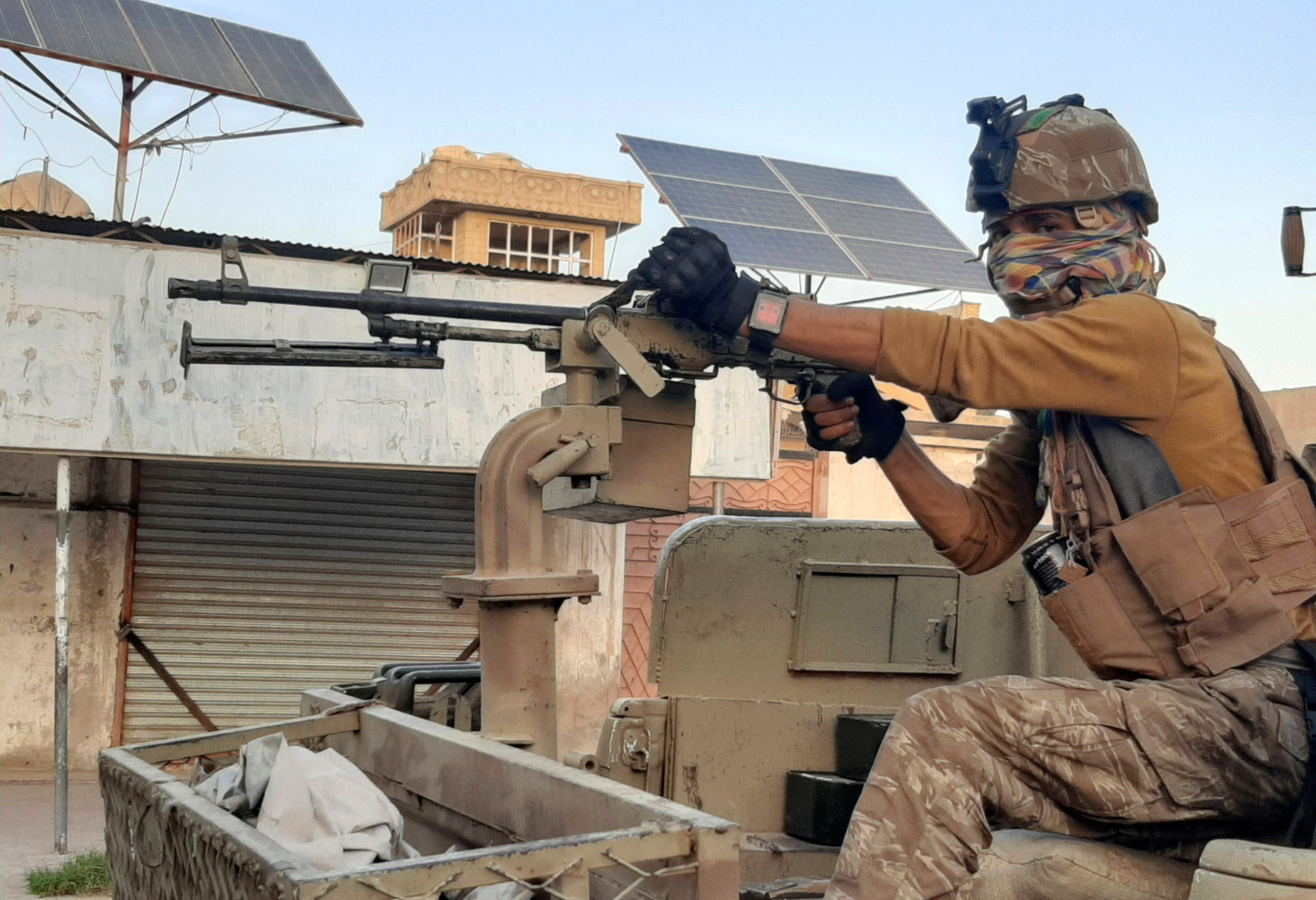 Afghan forces patrol during fighting with Taliban fighters in Lashkar Gah