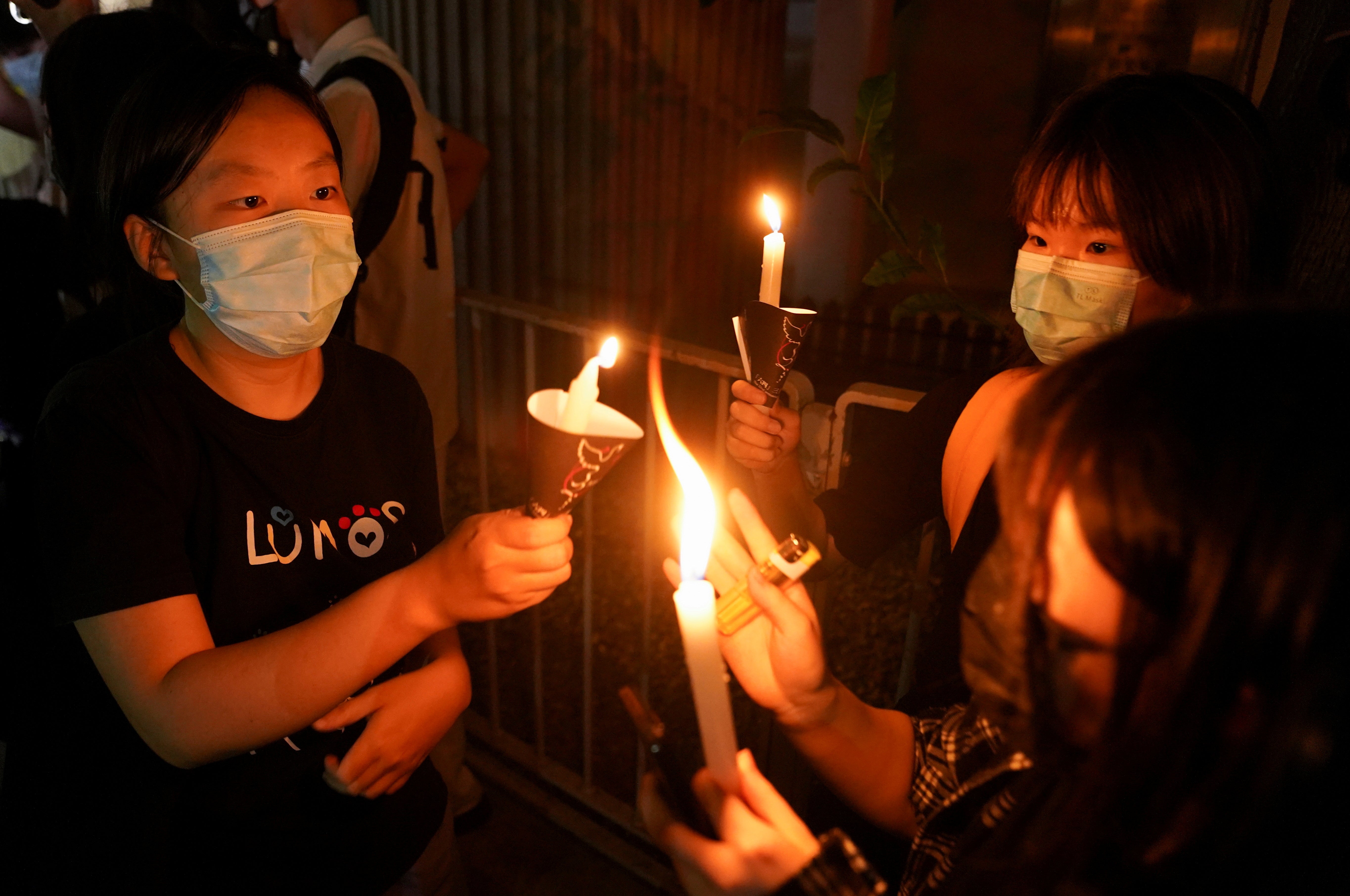 People light candles at Victoria Park on the 32nd anniversary of the crackdown on pro-democracy demonstrators at Beijing's Tiananmen Square in 1989, in Hong Kong, China 4 June 2021