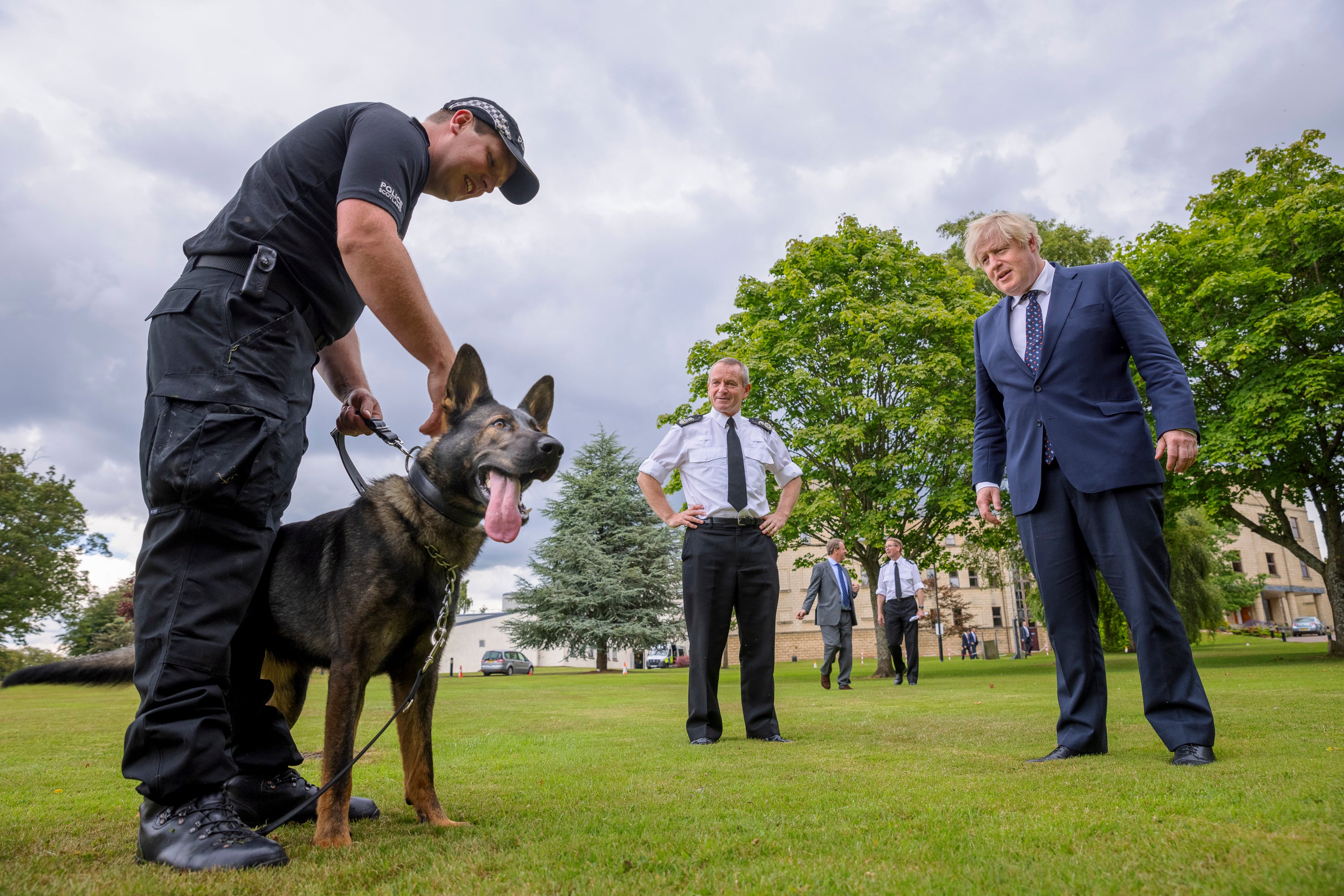 The prime minister, being photographed with police officers (and dog)