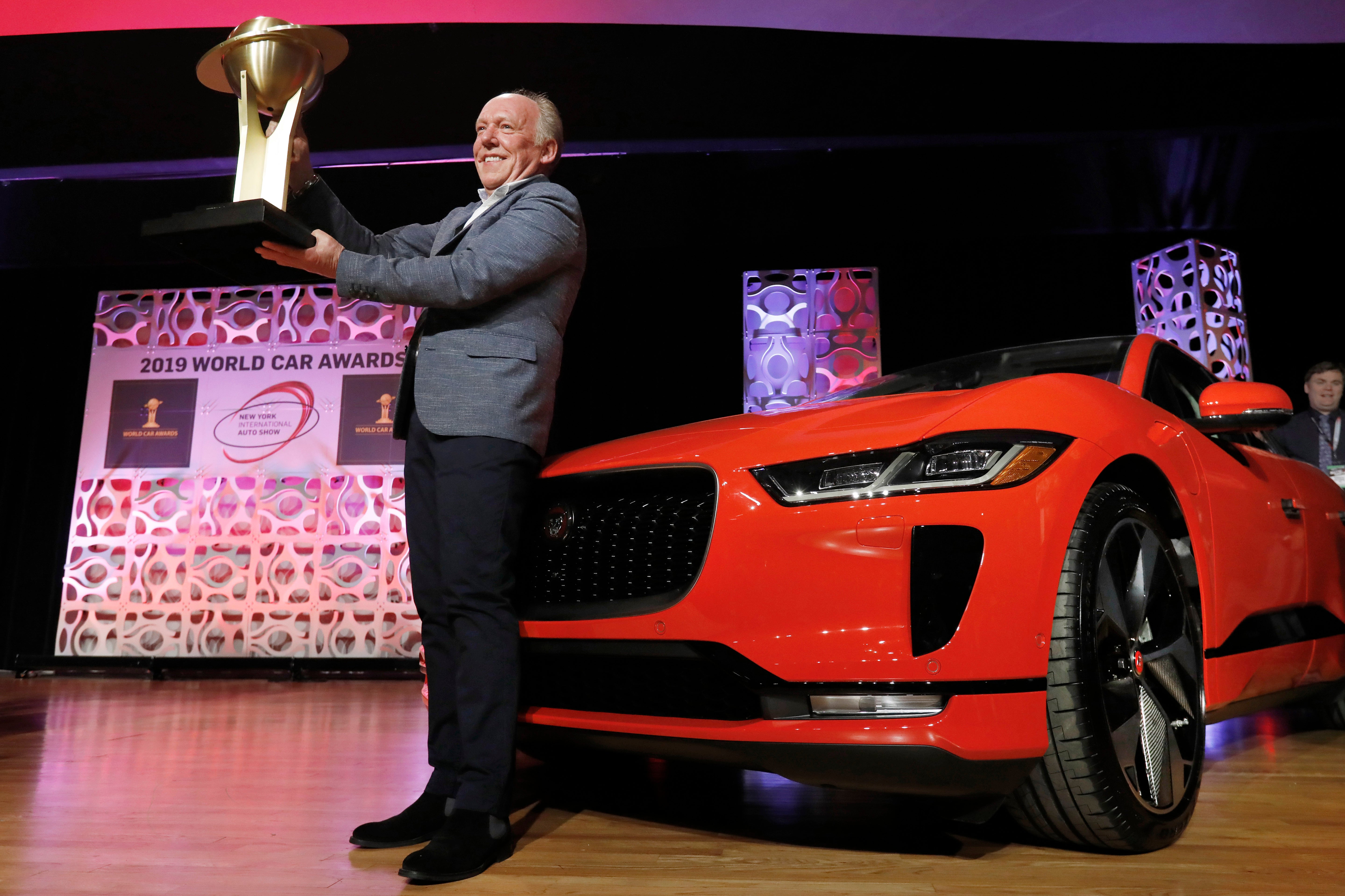 In this April 17, 2019 file photo, Jaguar Design Director Ian Callum raises the World Car of the Year trophy that was awarded to the Jaguar I-Pace