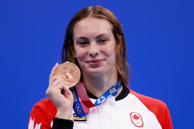 <p>Bronze medallist Canada's Penny Oleksiak poses with her medal on the podium after the final of the women's 200m freestyle swimming event during the Tokyo 2020 Olympic Games at the Tokyo Aquatics Centre in Tokyo on July 28, 2021. </p>