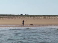 Fishermen rescue woman forced to fight wild coyote off with a stick 