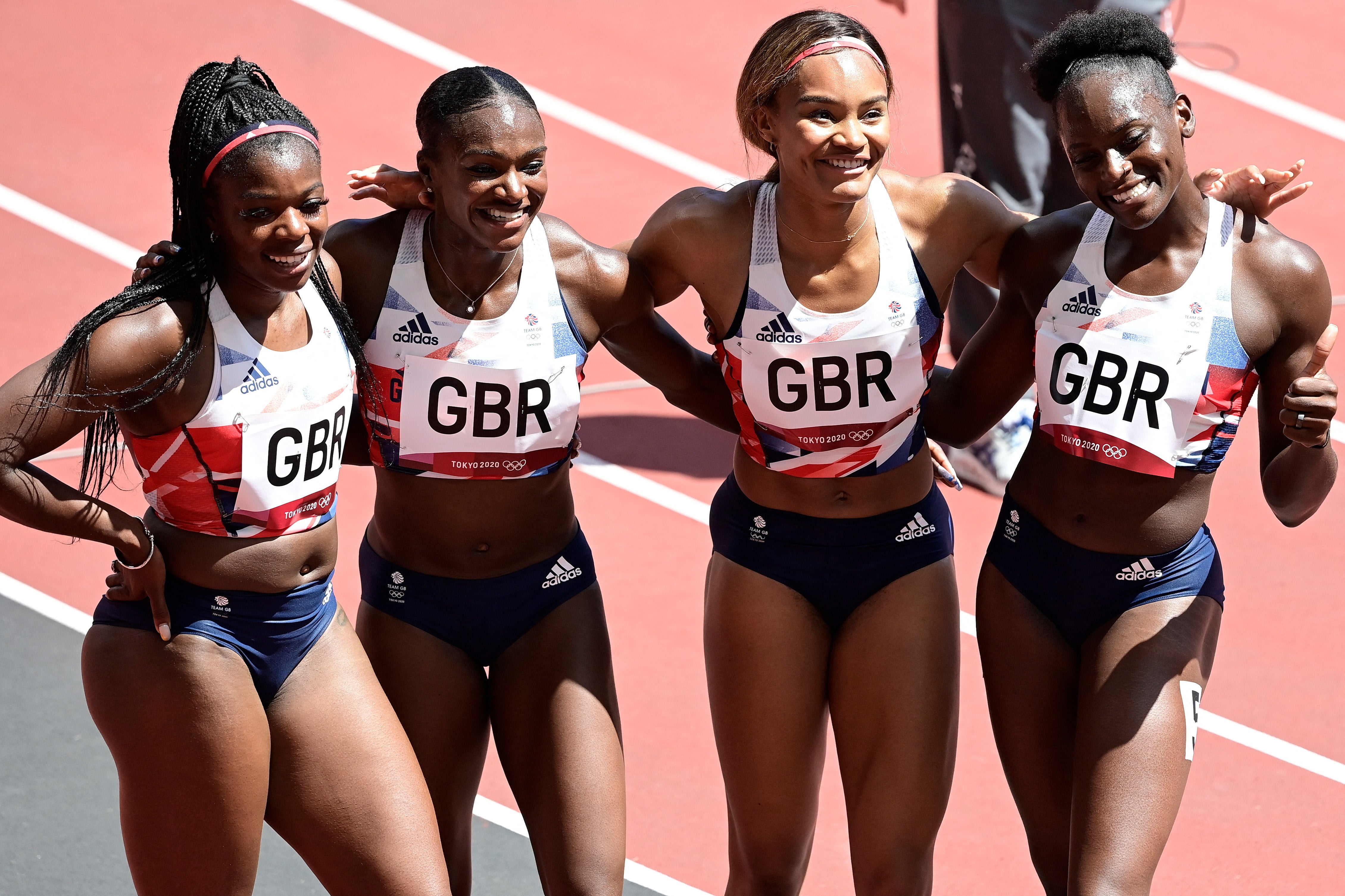Britain's Asha Philip, Britain's Dina Asher-Smith, Britain's Imani Lansiquot and Britain's Daryll Neita pose after winning in the women's 4x100m relay heats during the Tokyo 2020 Olympic Games at the Olympic Stadium in Tokyo on August 5, 2021.