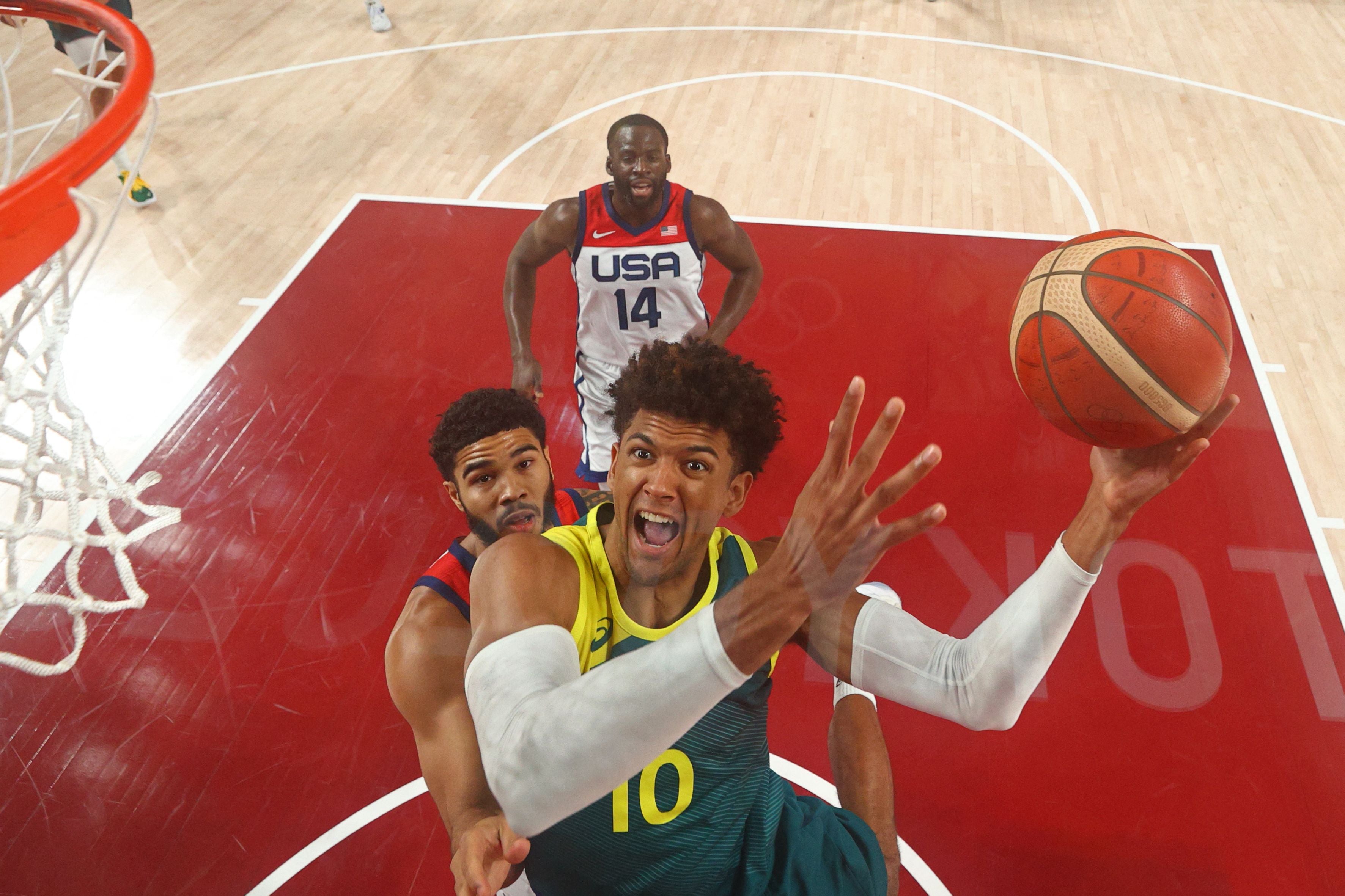 Matisse Thybulle goes to the basket past Jayson Tatum