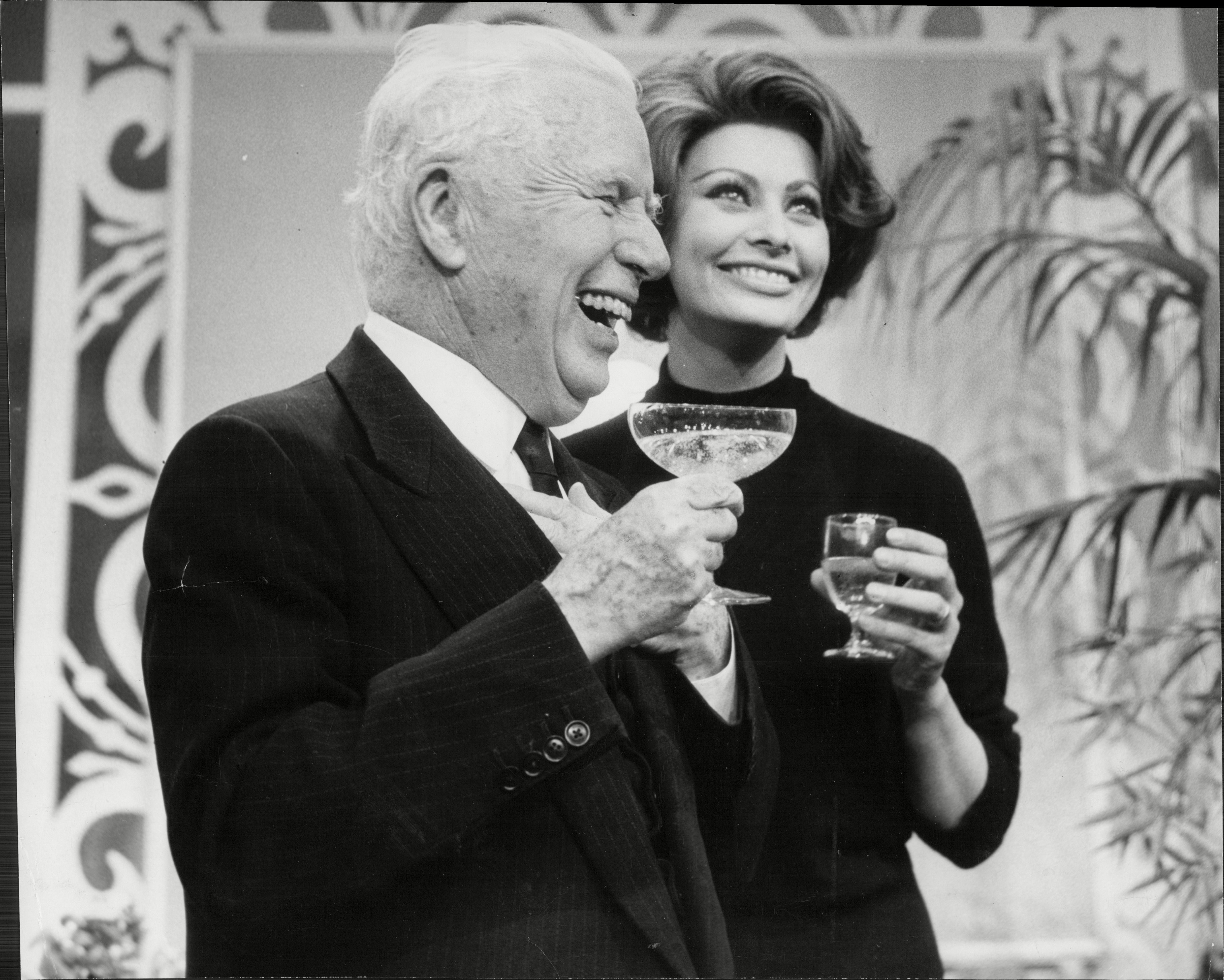 Charlie Chaplin with Sophia Loren, celebrating his 77th birthday