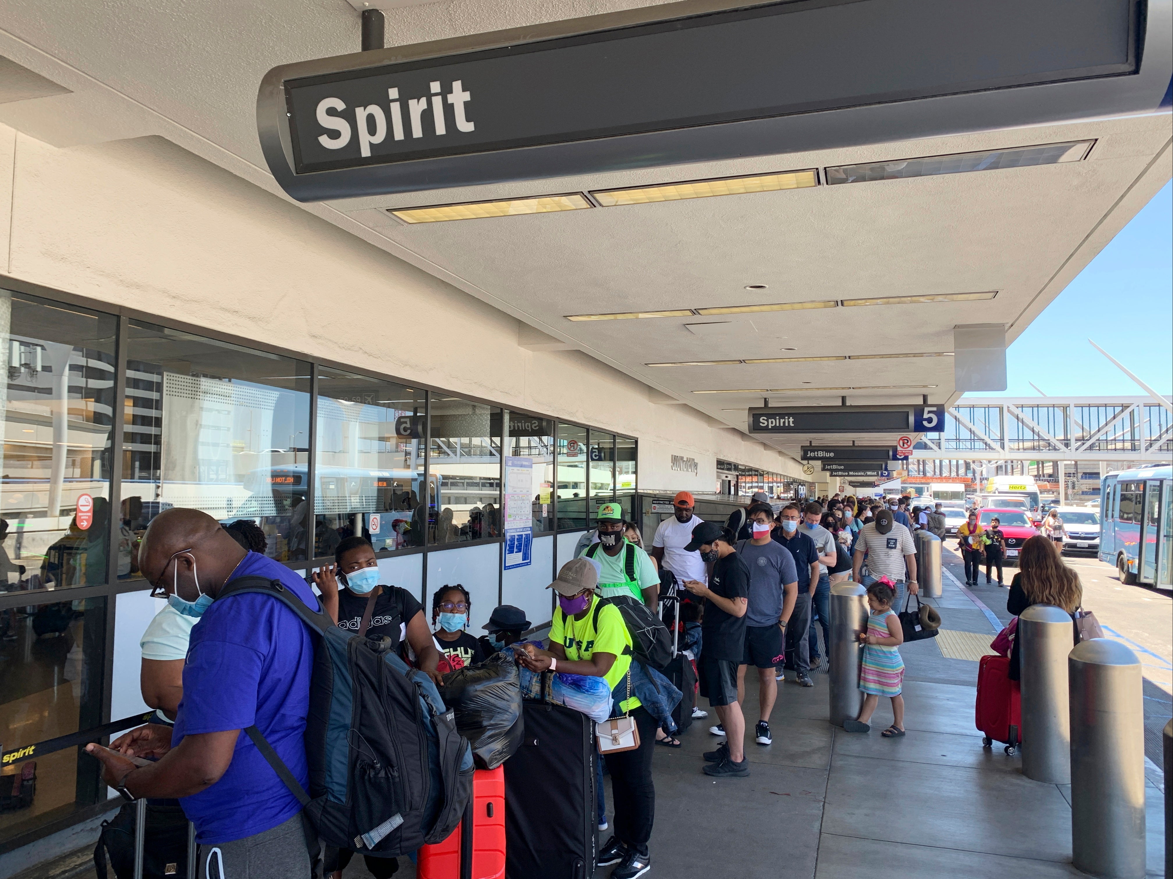 <p>Passengers line up outside the Spirit Airlines terminal at Los Angeles International Airport in Los Angeles on Tuesday, 3 August 2021</p>