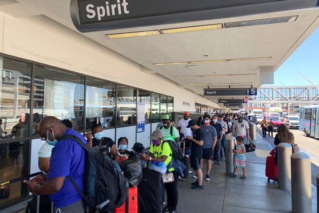 <p>Passengers line up outside the Spirit Airlines terminal at Los Angeles International Airport in Los Angeles on Tuesday, 3 August 2021</p>