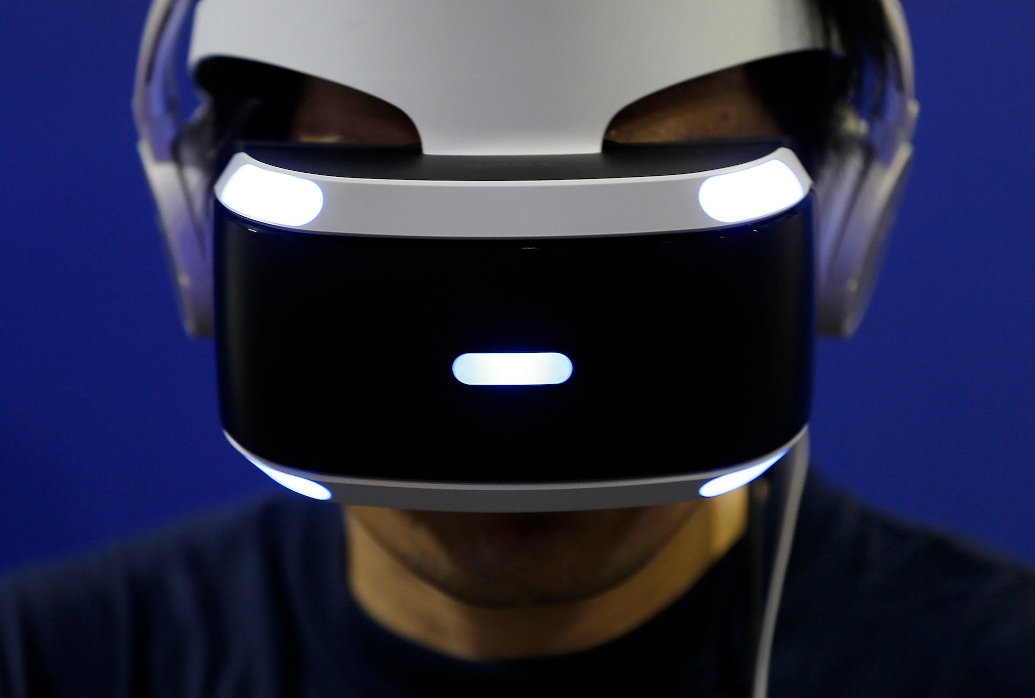 A visitor wearing a PlayStation VR headset plays a video game in the Sony Interactive Entertainment Inc. booth at Tokyo Game Show
