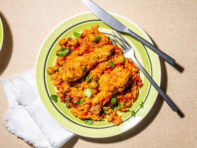 <p>Tinted rouge with achiote oil, this arroz con pollo is a gorgeous mess of chicken, rice, coriander and olives</p>