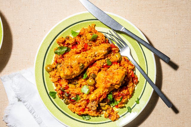 <p>Tinted rouge with achiote oil, this arroz con pollo is a gorgeous mess of chicken, rice, coriander and olives</p>