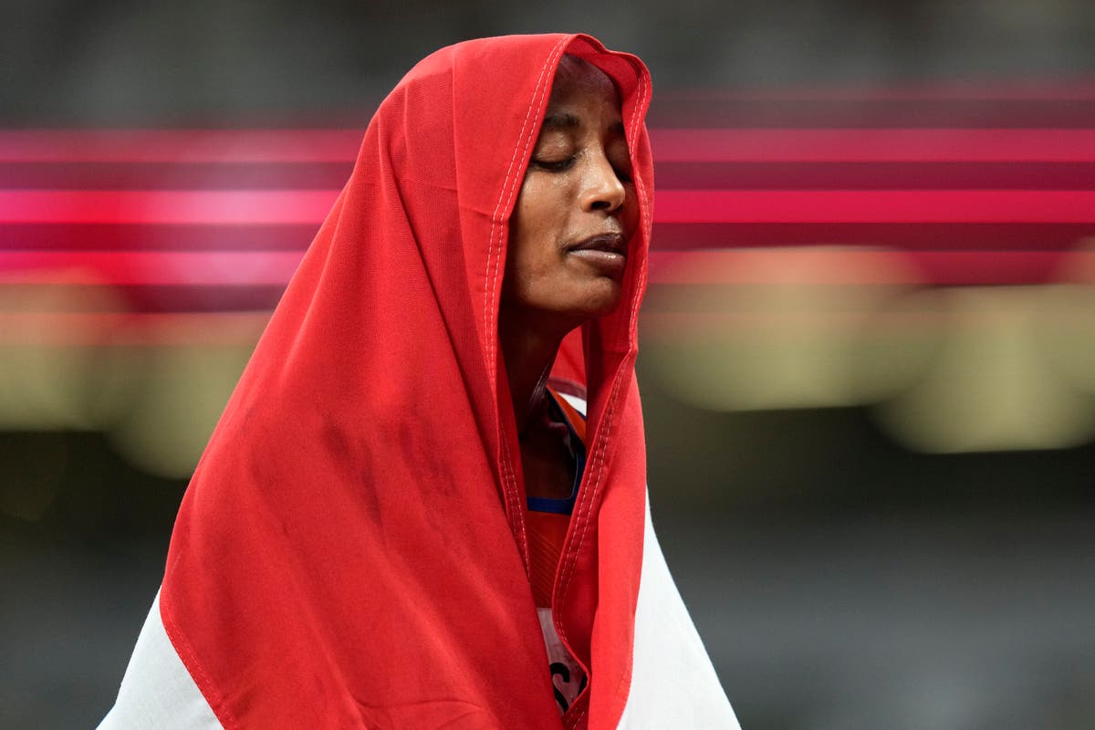 AP PHOTOS: Olympians proudly display their national flags