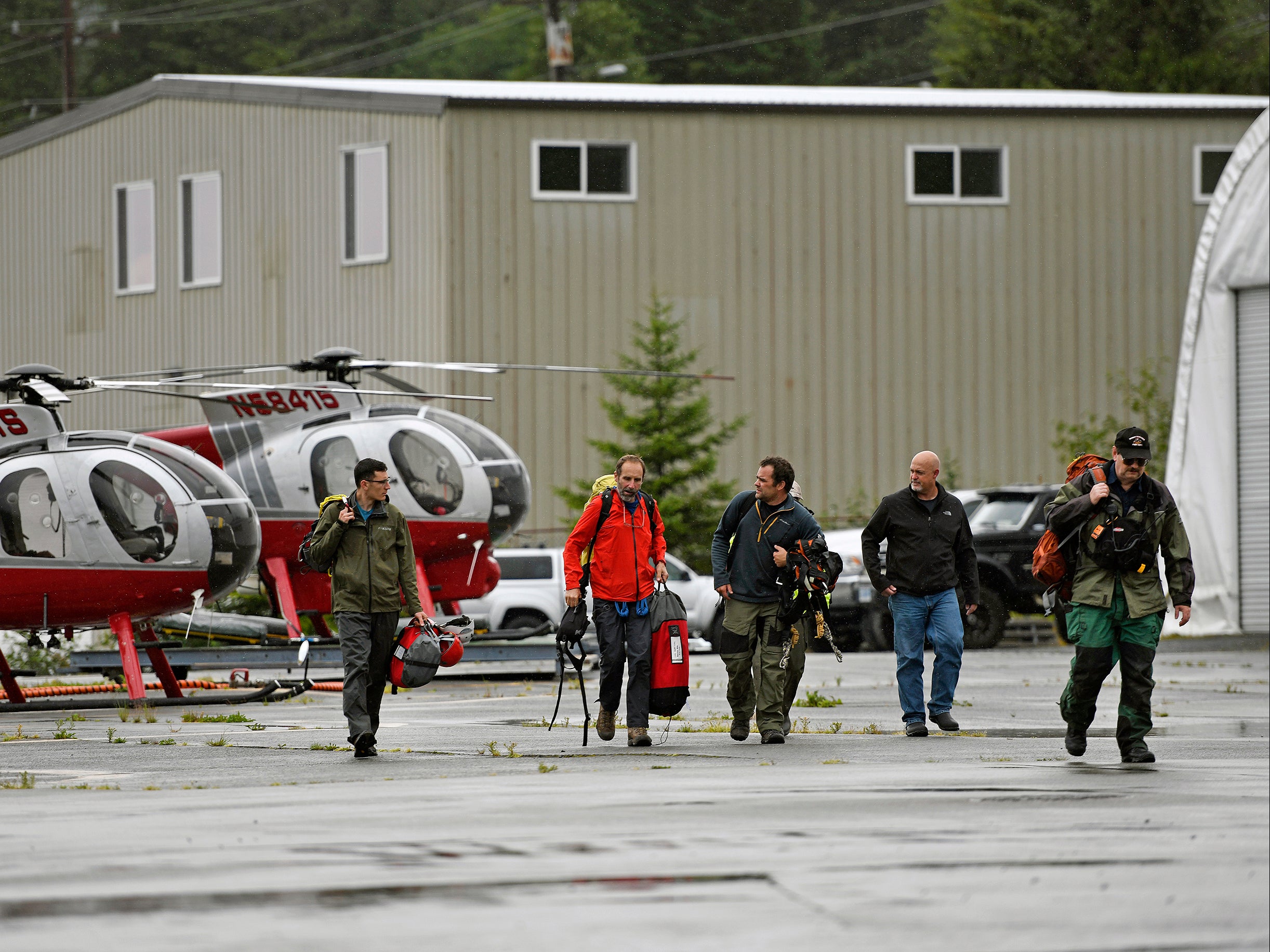 Ketchikan Volunteer Rescue Squad personnel land and disembark from a Hughes 369D helicopter on Thursday, 5 August 2021