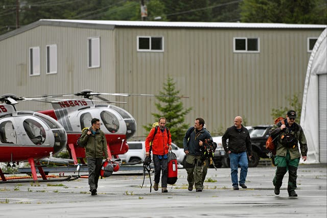 <p>Ketchikan Volunteer Rescue Squad personnel land and disembark from a Hughes 369D helicopter on Thursday, 5 August 2021</p>