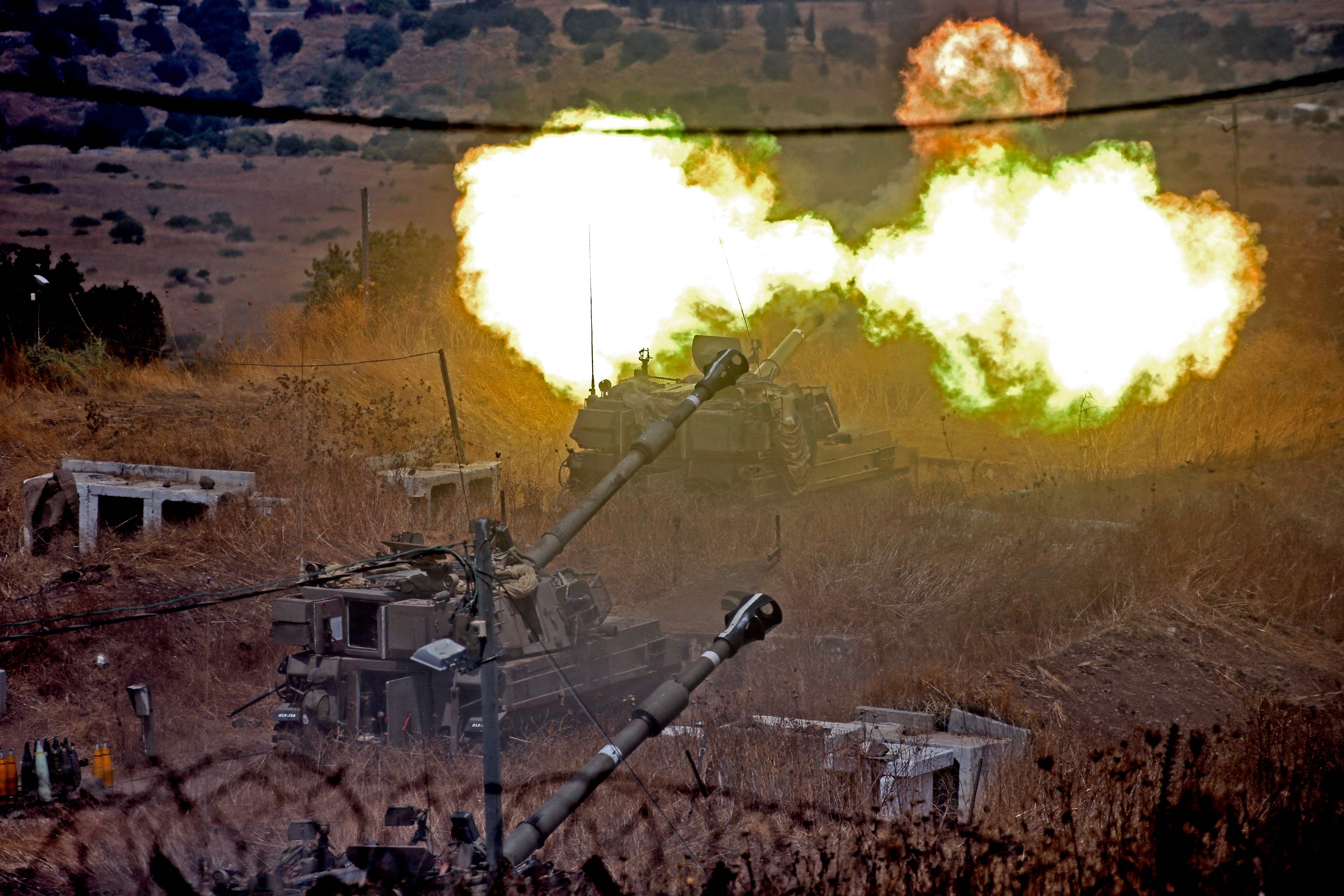 Israeli self-propelled howitzers fire towards Lebanon after rockets were targeted at Israel